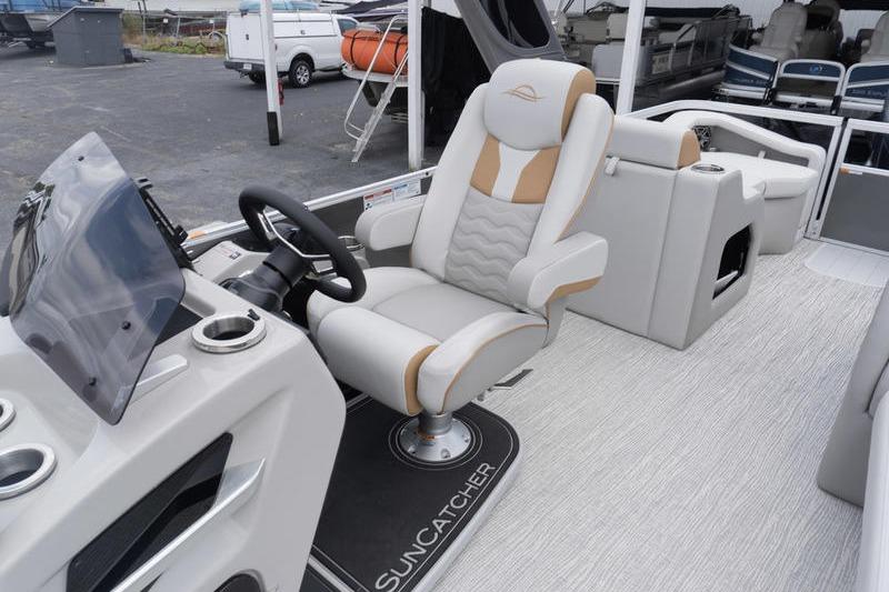 2026 SunCatcher Elite 326 SS boat interior with luxurious captain's chair and modern dashboard.