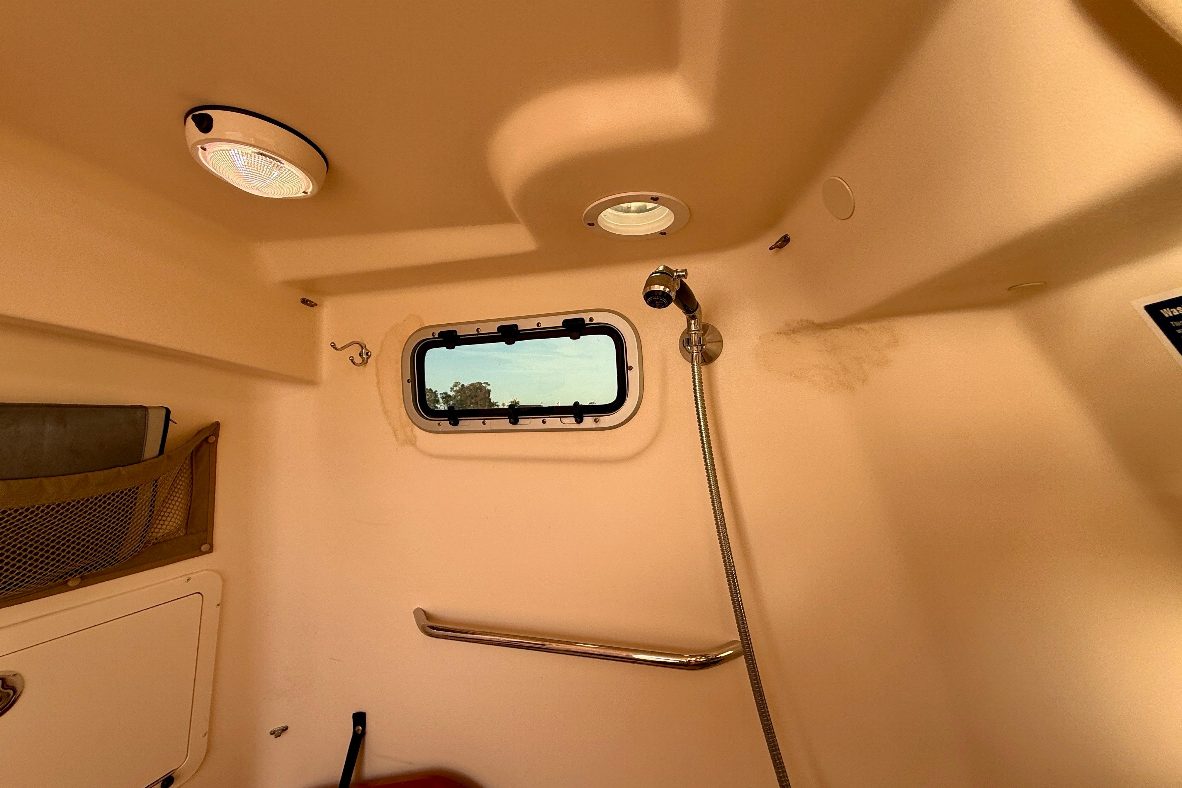 Interior of 2012 Grady-White Canyon 336 boat cabin with window and showerhead.