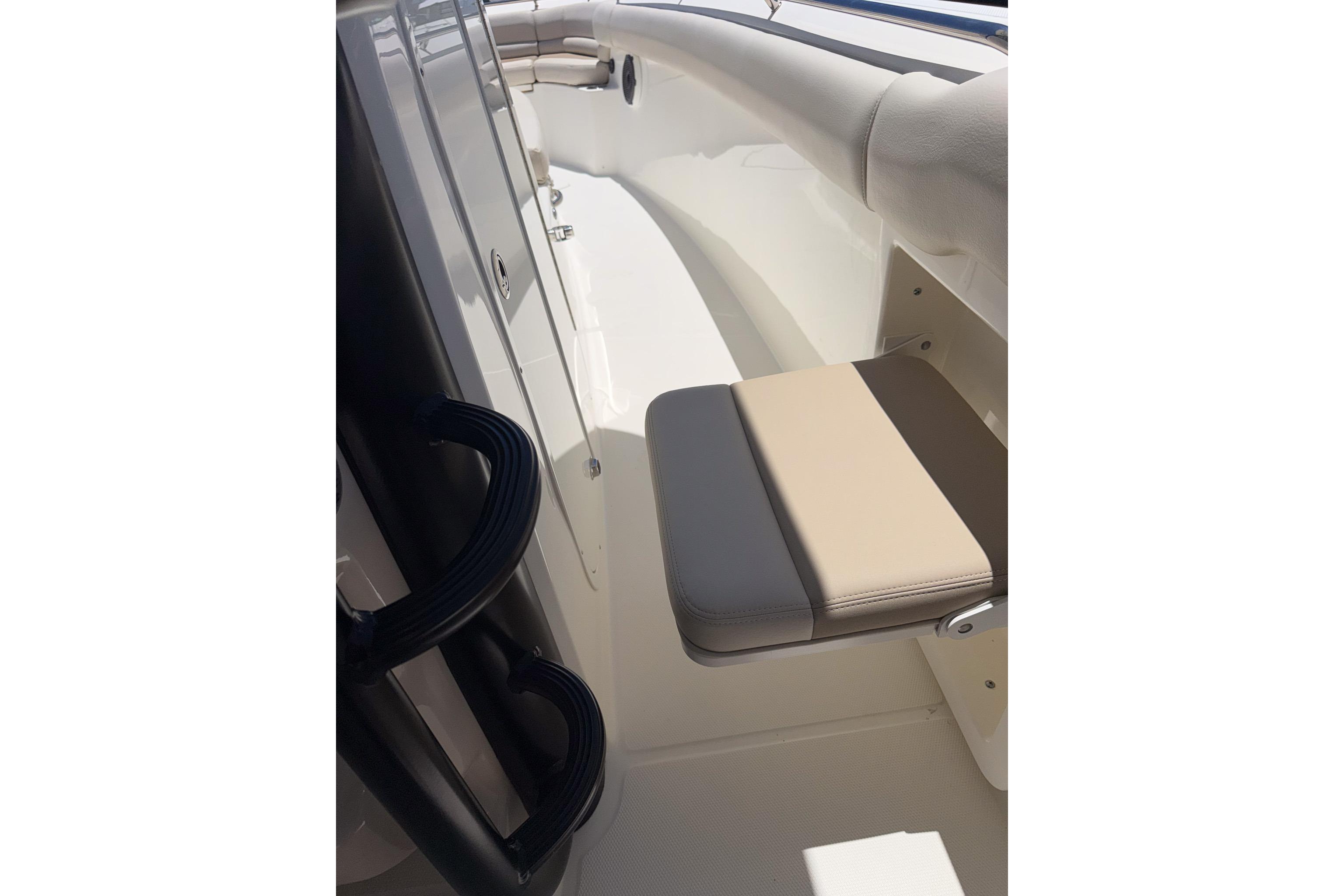 2021 Boston Whaler 330 Outrage interior with beige seating and sleek design.