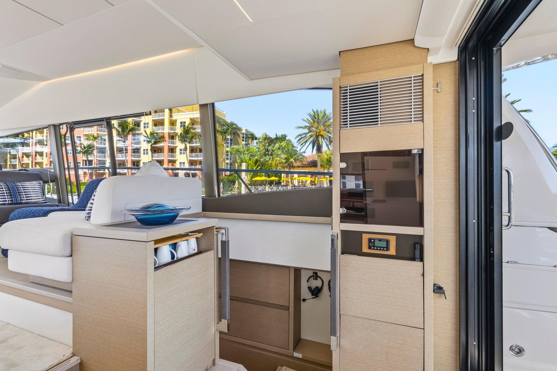 Luxurious interior of 2022 Prestige 520 yacht with modern furnishings and large windows.
