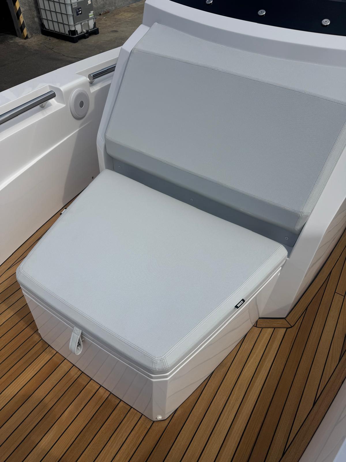 Luxury seating on 2026 Pirelli 30 boat with sleek design and wooden deck.