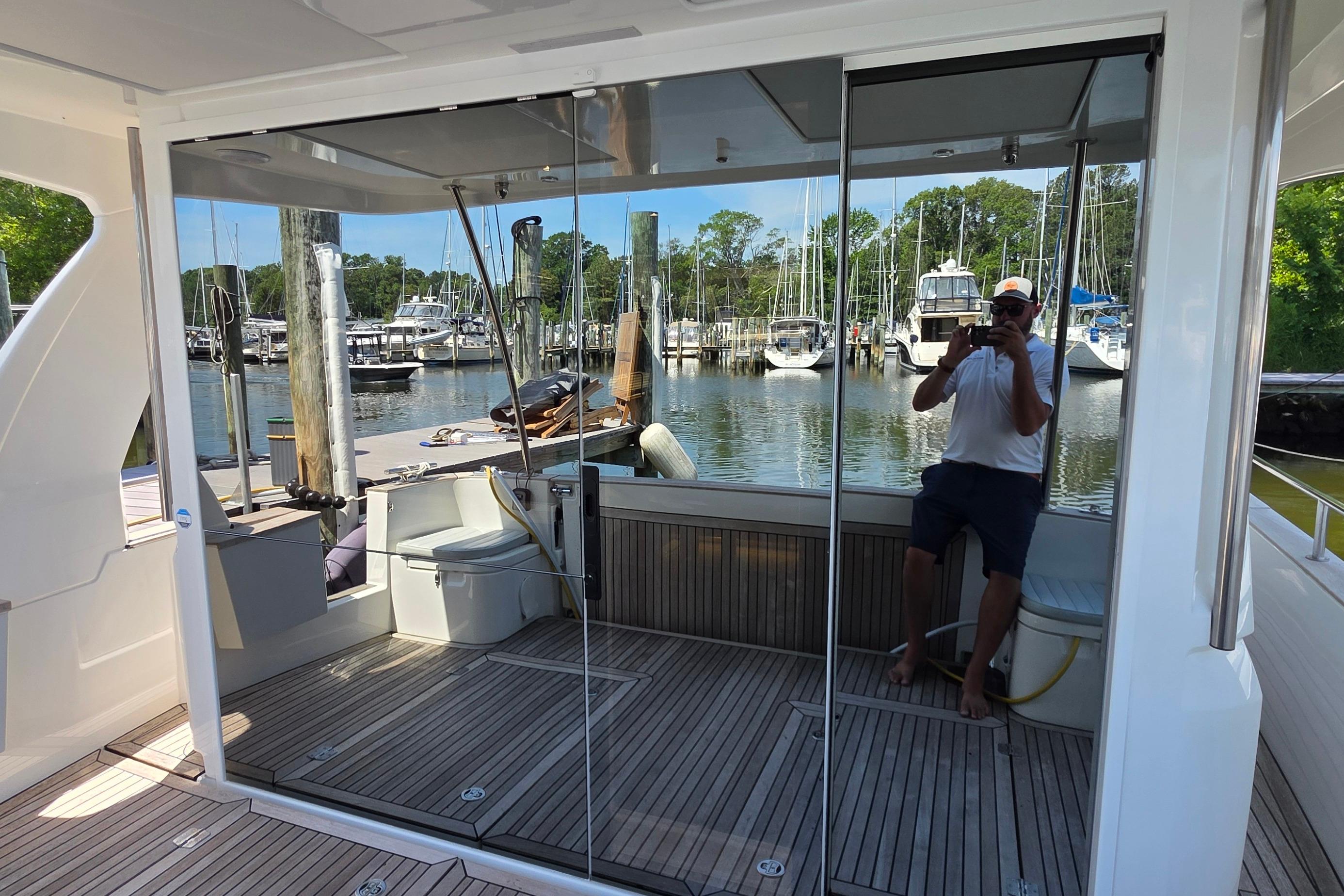 2023 Greenline 40 yacht interior with mirrored doors, docked at a marina.
