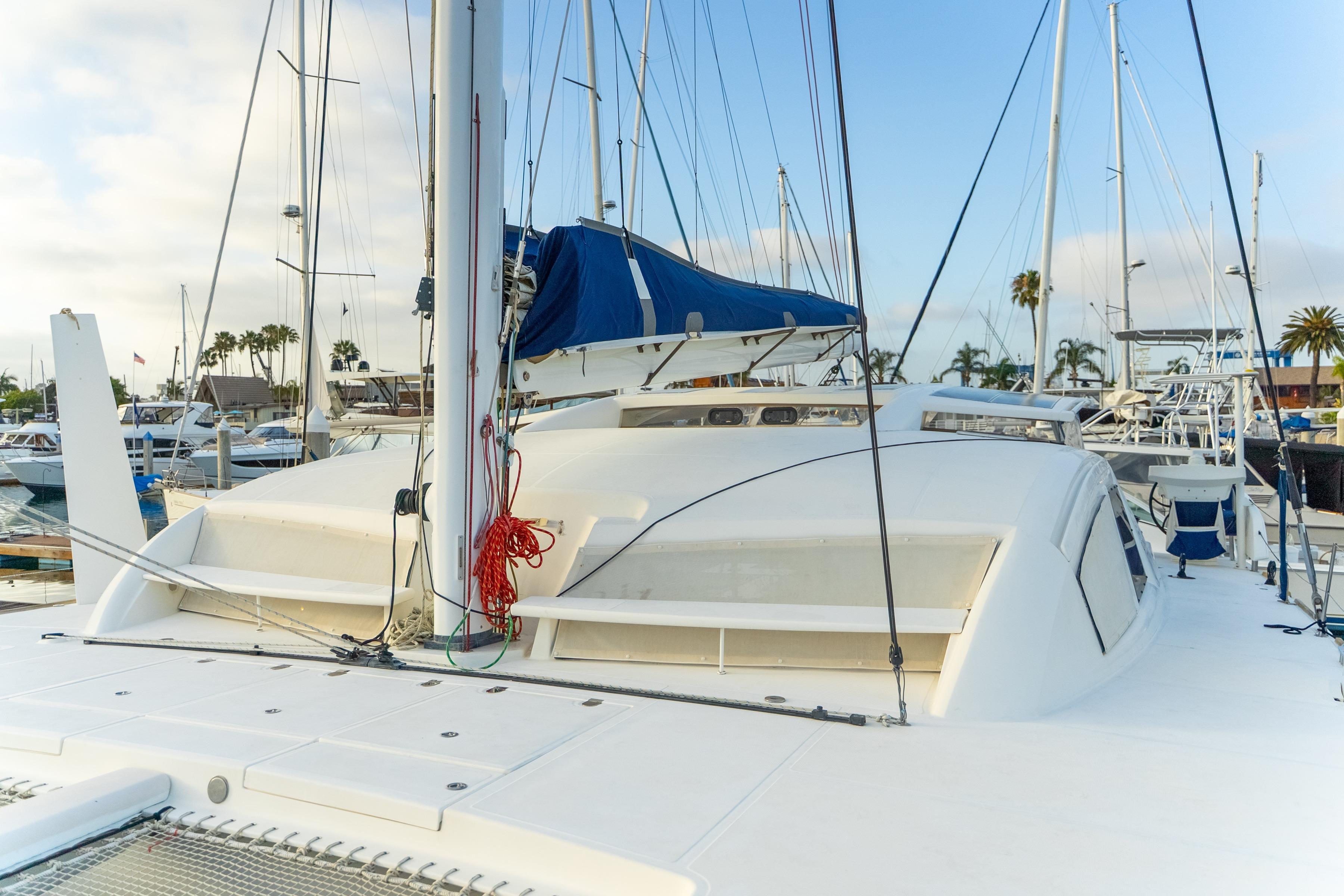 2009 Catana 65 catamaran docked at marina with blue sail cover.