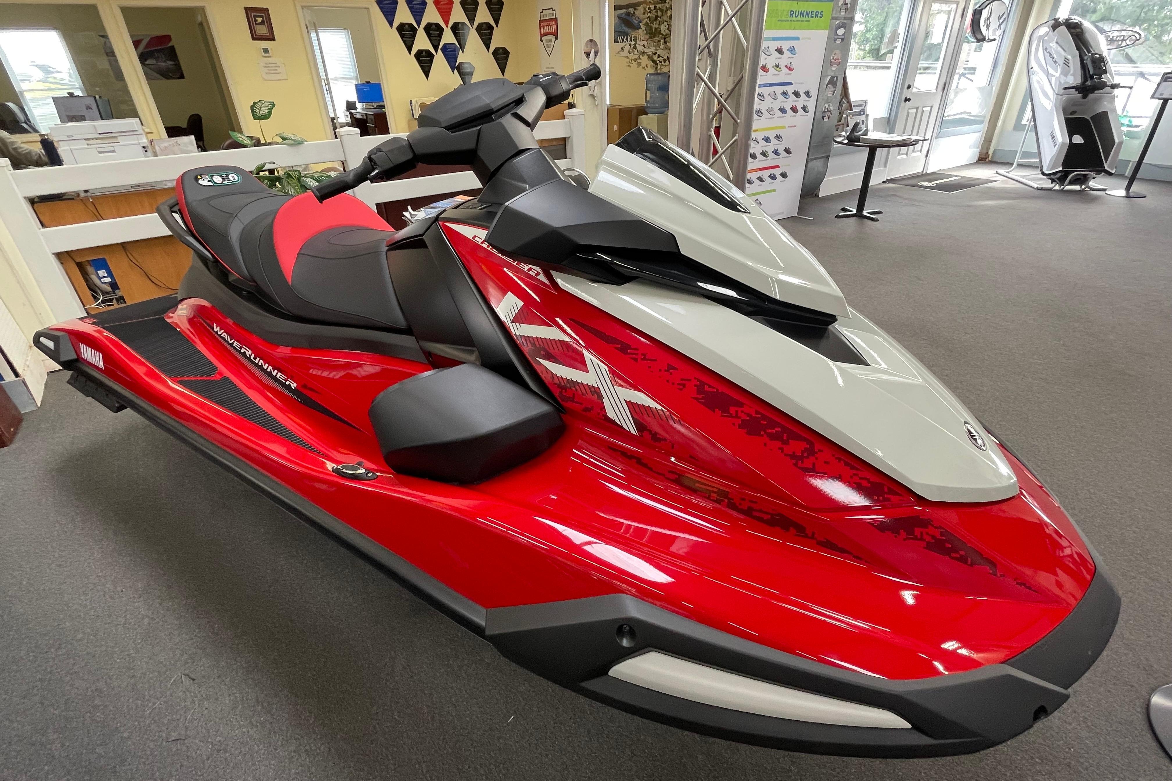 2026 Yamaha WaveRunner VX Cruiser in showroom, vibrant red and gray design.