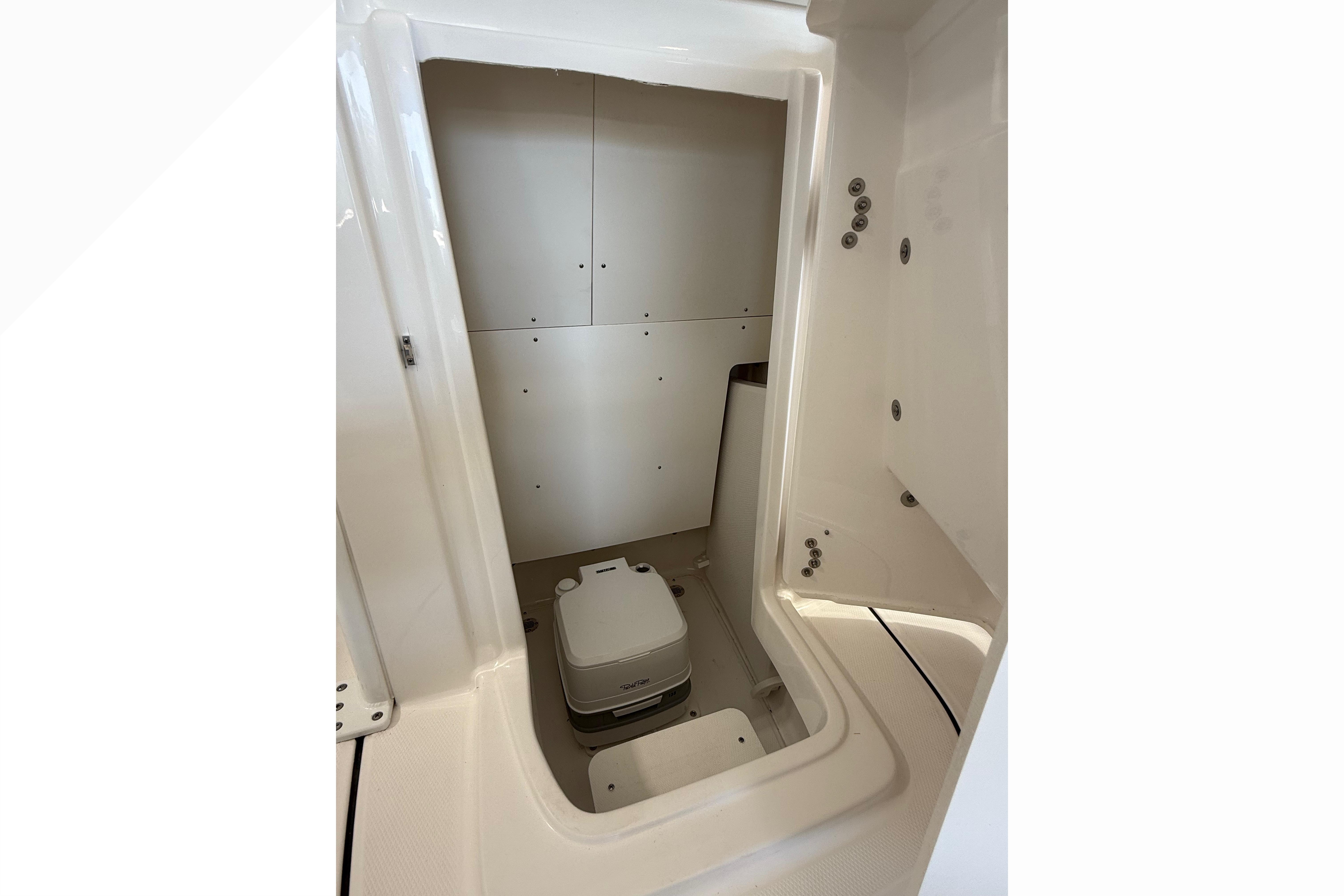 2026 Robalo 246 Cayman boat interior with compact toilet compartment.