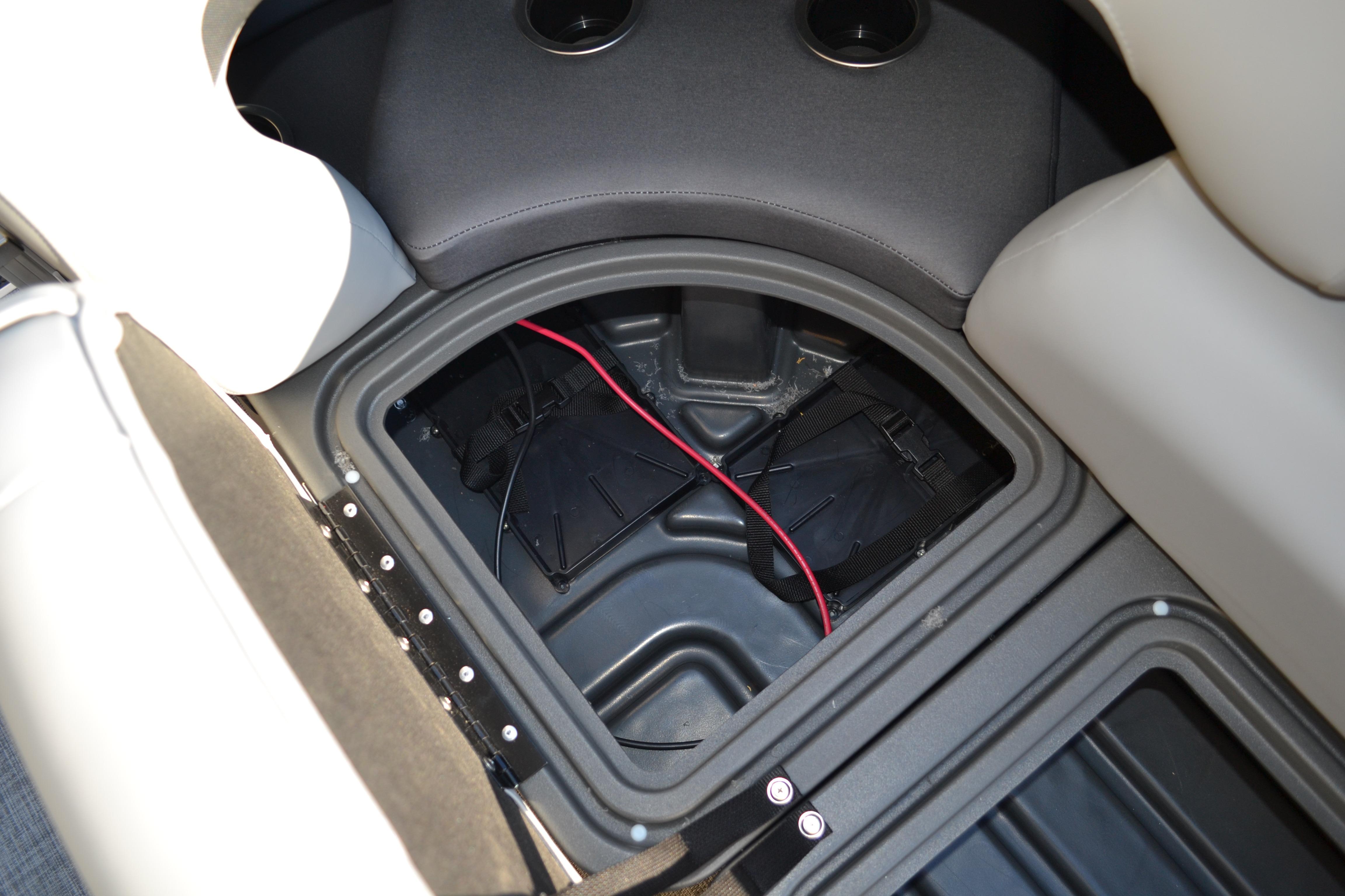 2026 Sun Tracker SportFish 22 XP3 storage compartment with wiring and cup holders.