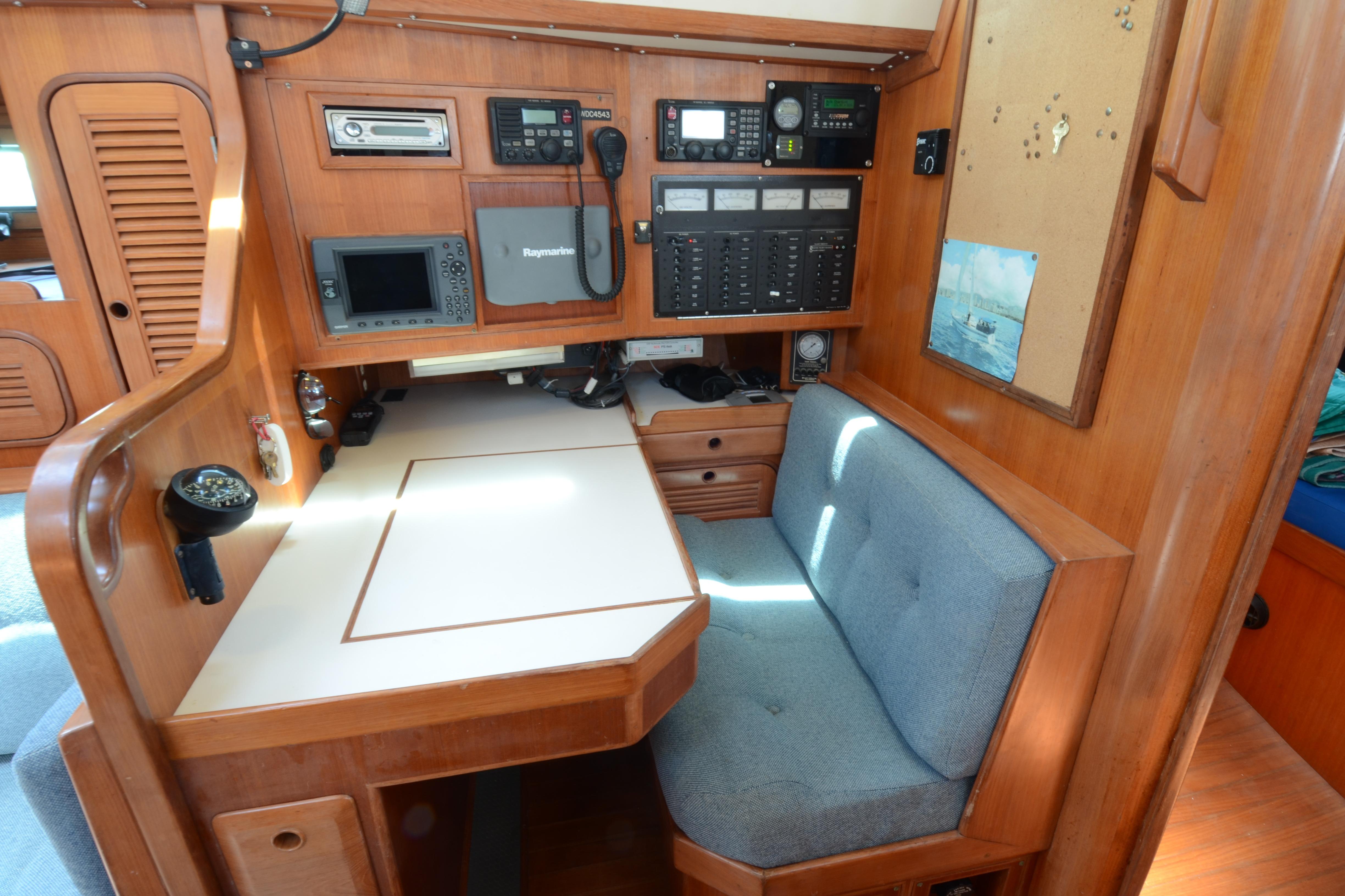 Navigation station inside 1987 Norseman 400 yacht with control panels and seating.