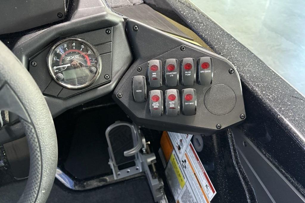 Control panel of 2026 Skeeter ZXE21 boat with switches and gauge.