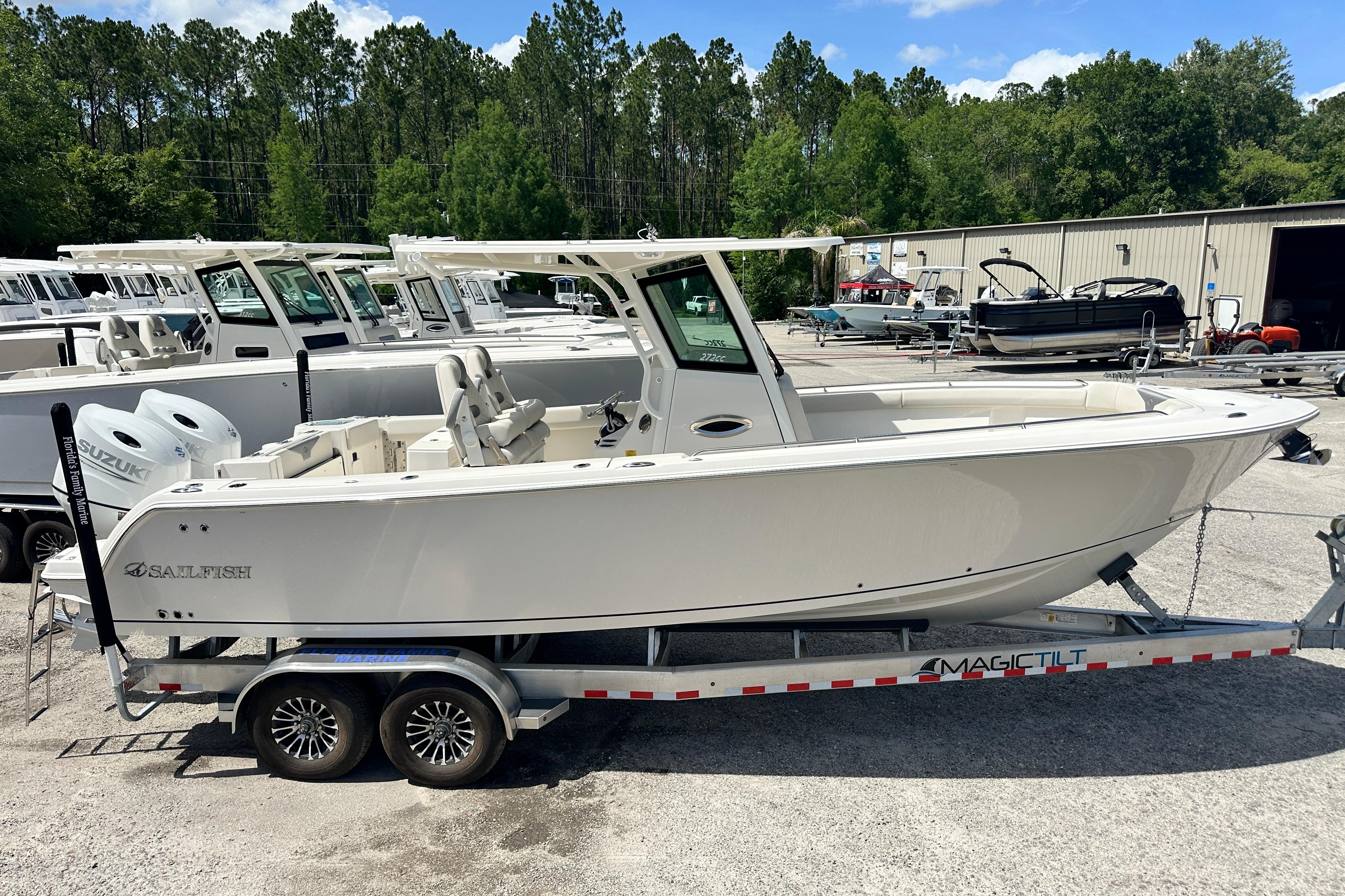 2026 Sailfish 272 CC boat on trailer, parked in a marina with other boats.