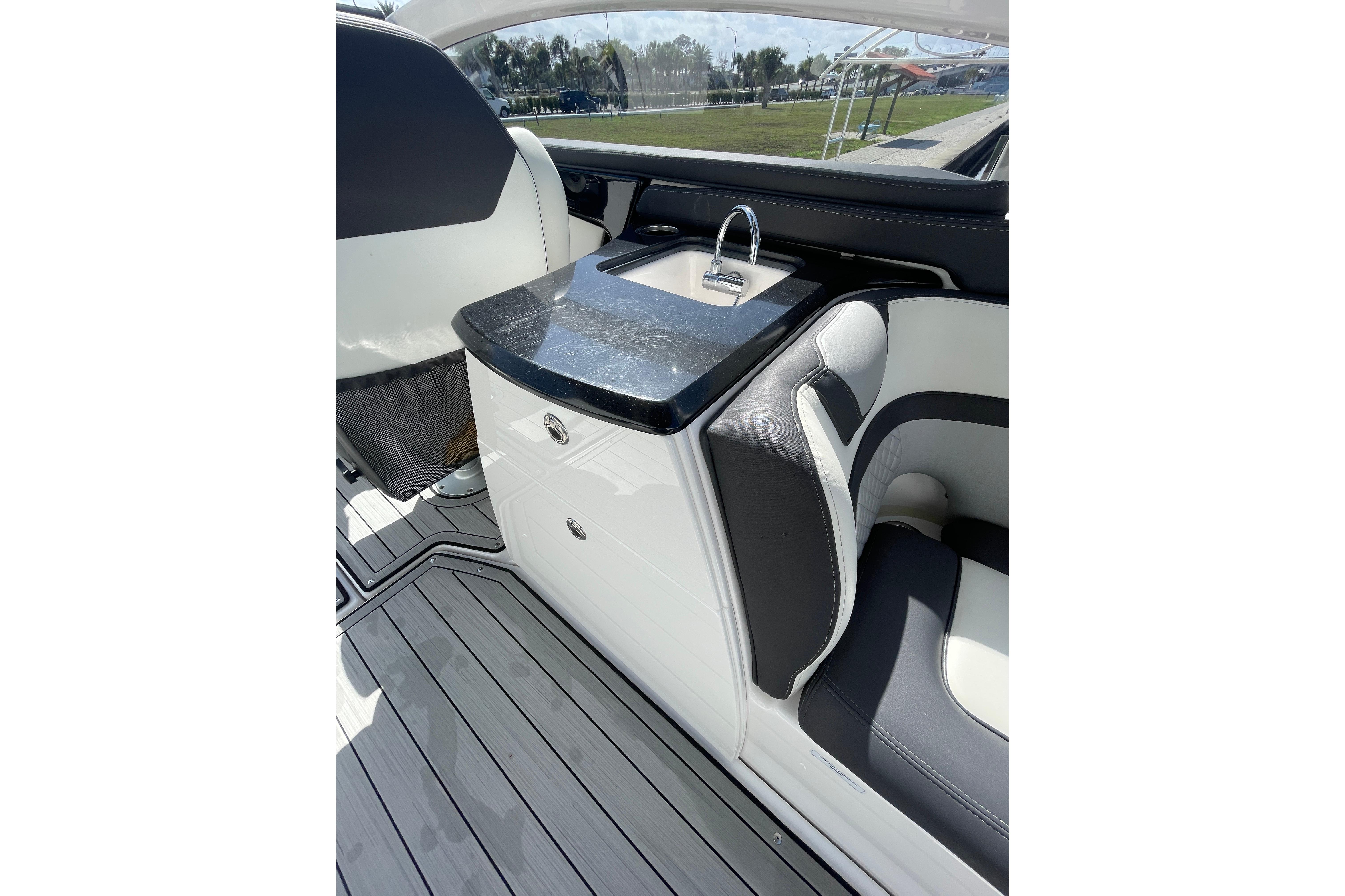 2021 Yamaha Boats 275SE interior with sleek seating and compact sink area.