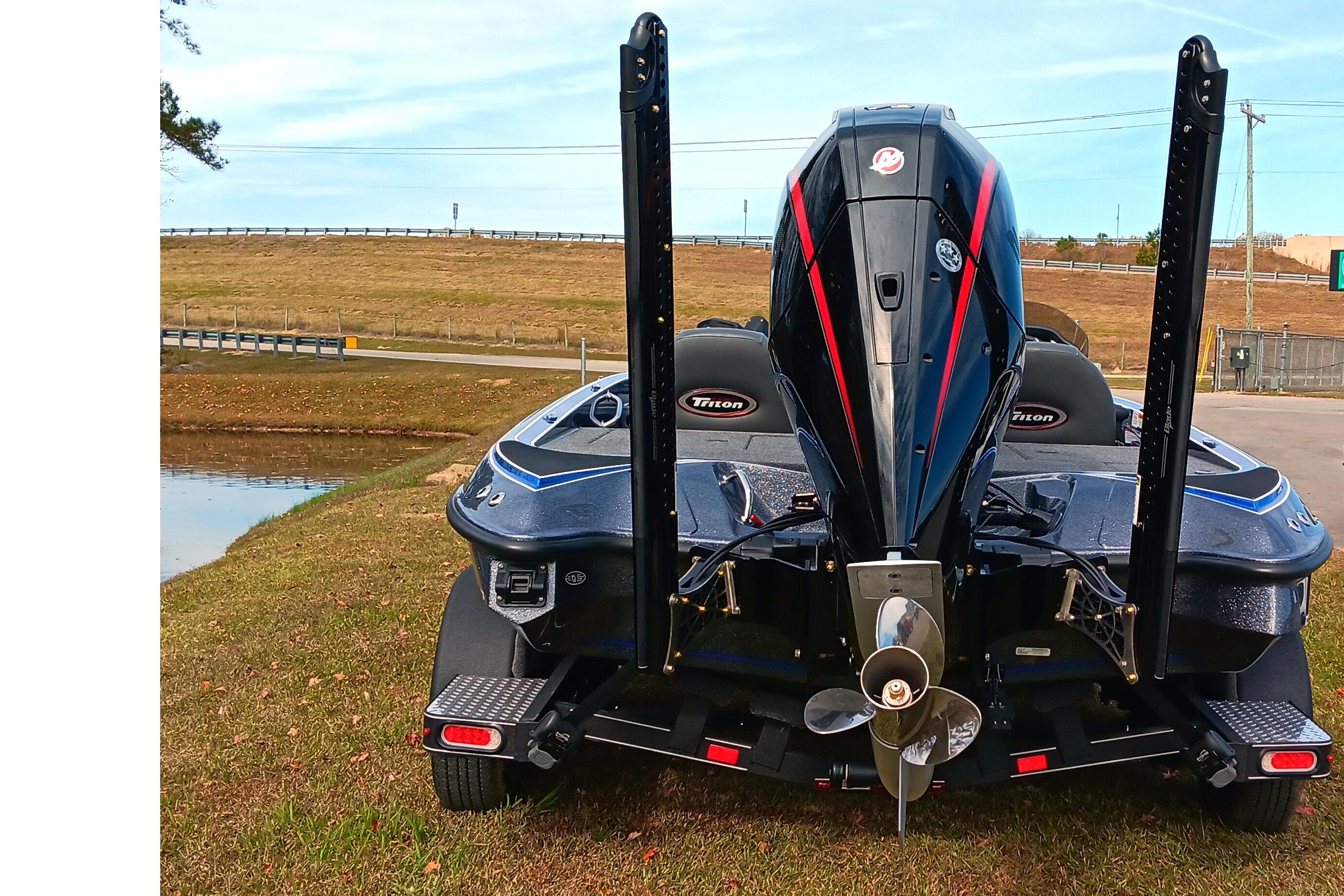 2026 Triton 18 TrX boat rear view with powerful outboard motor on trailer.