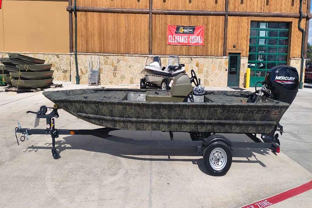 2026 Tracker Grizzly 1648 SC boat with Mercury engine on trailer, outdoor display.