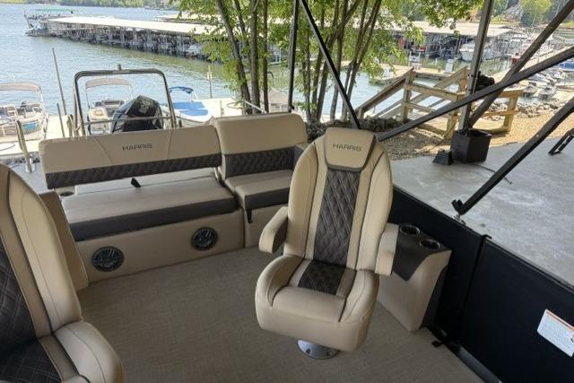 2025 Harris Sunliner 230 pontoon boat interior with luxurious seating and lake view.