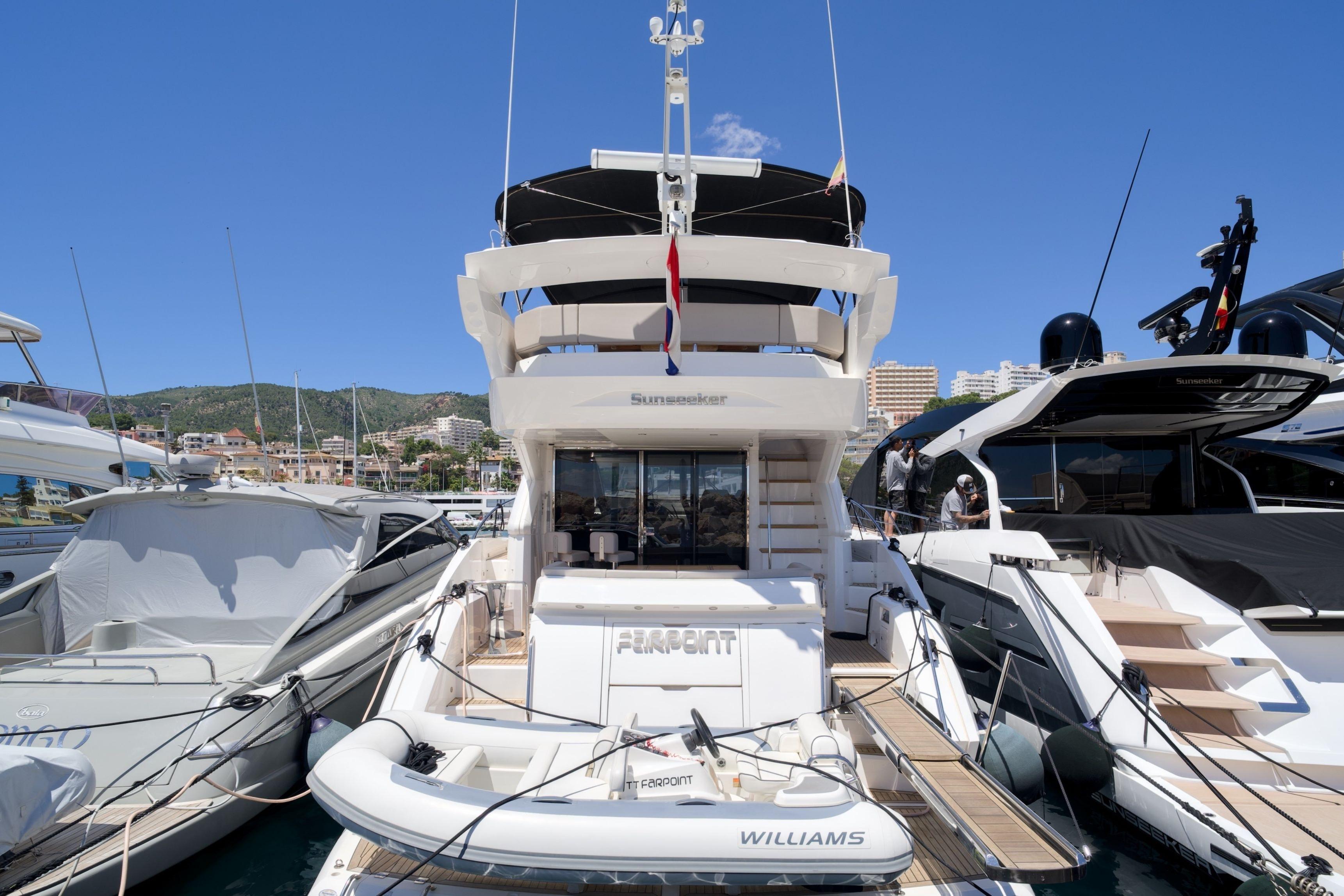 2019 Sunseeker Manhattan 52 yacht docked at marina, featuring sleek design and luxury amenities.