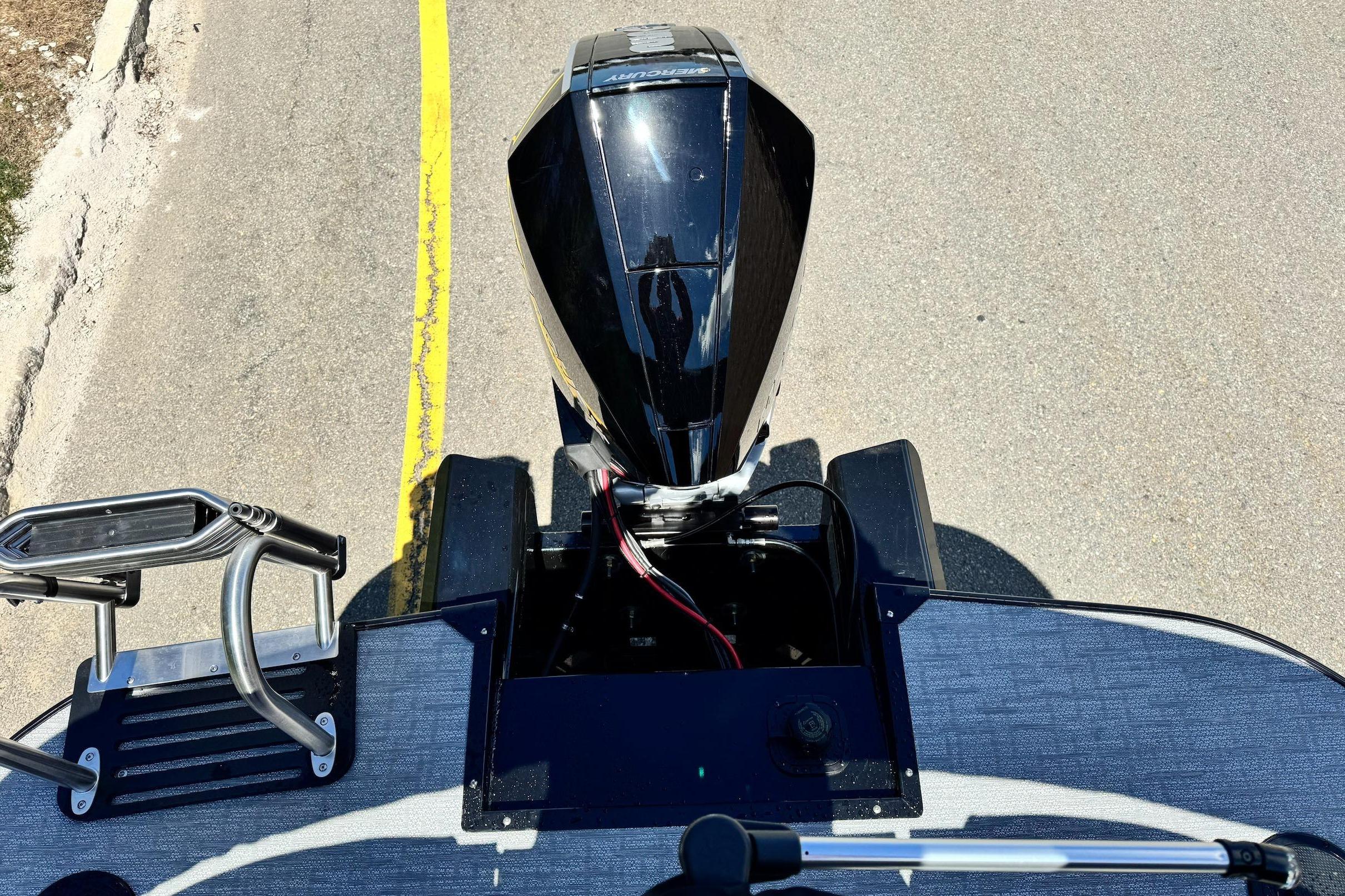 Regency 230 DL 2026 boat motor on road, top view.
