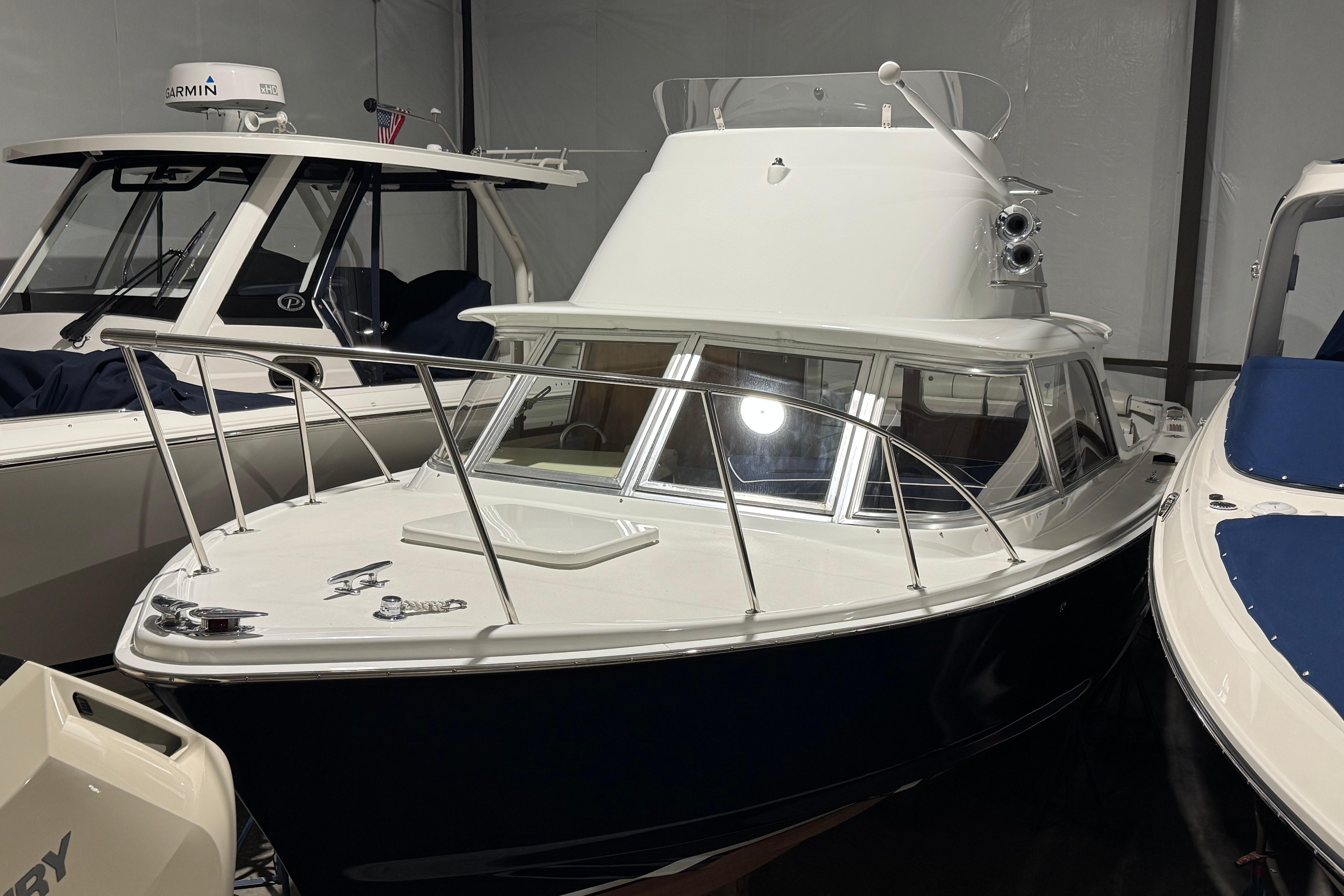 1974 Bertram 31 Flybridge Cruiser in storage, showcasing classic design and sleek lines.