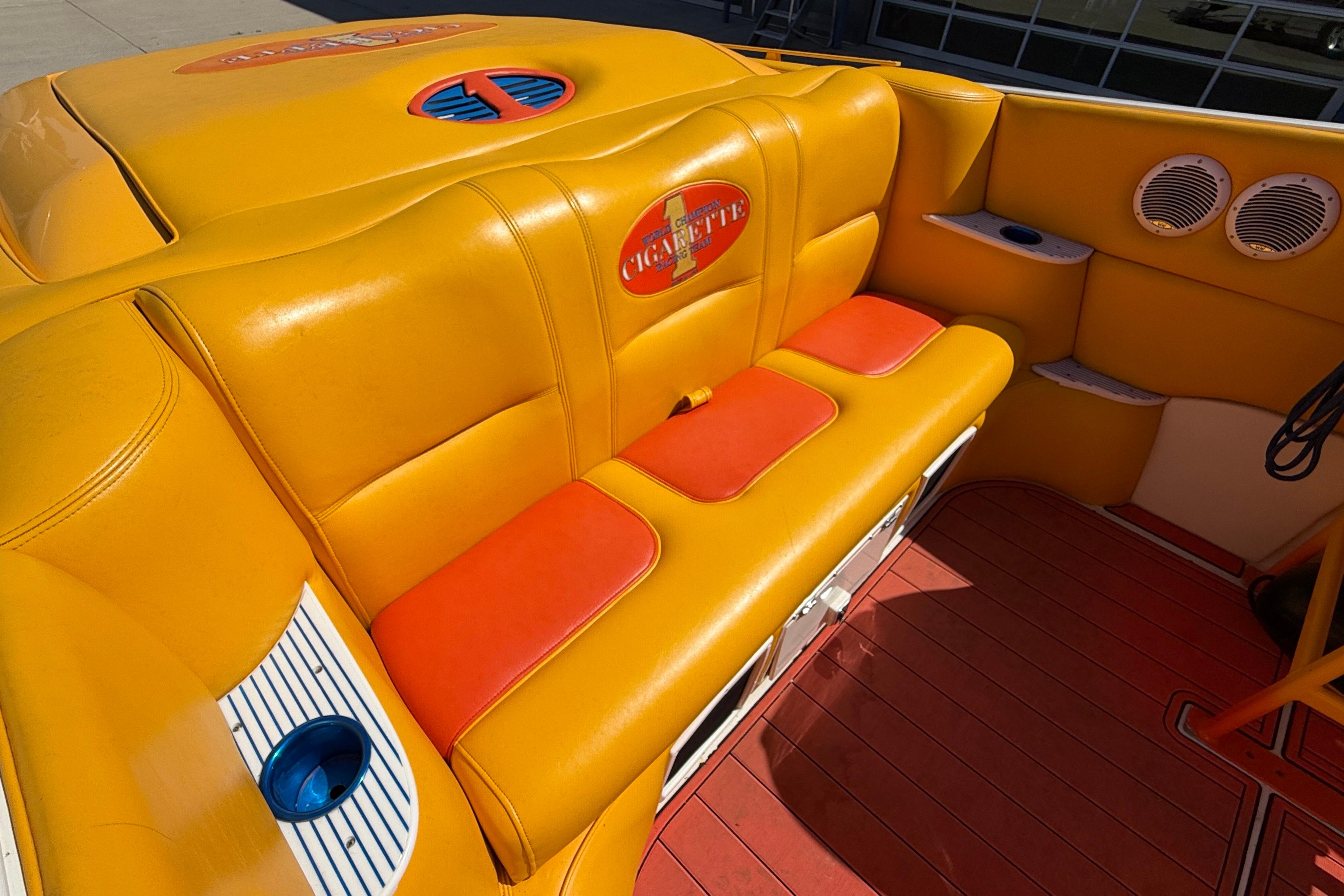 Yellow and orange seating in a 2002 Cigarette 35' Cafe Racer boat interior.
