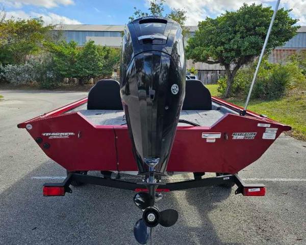 2025 Tracker Pro Team 175 boat with outboard motor, parked outdoors.