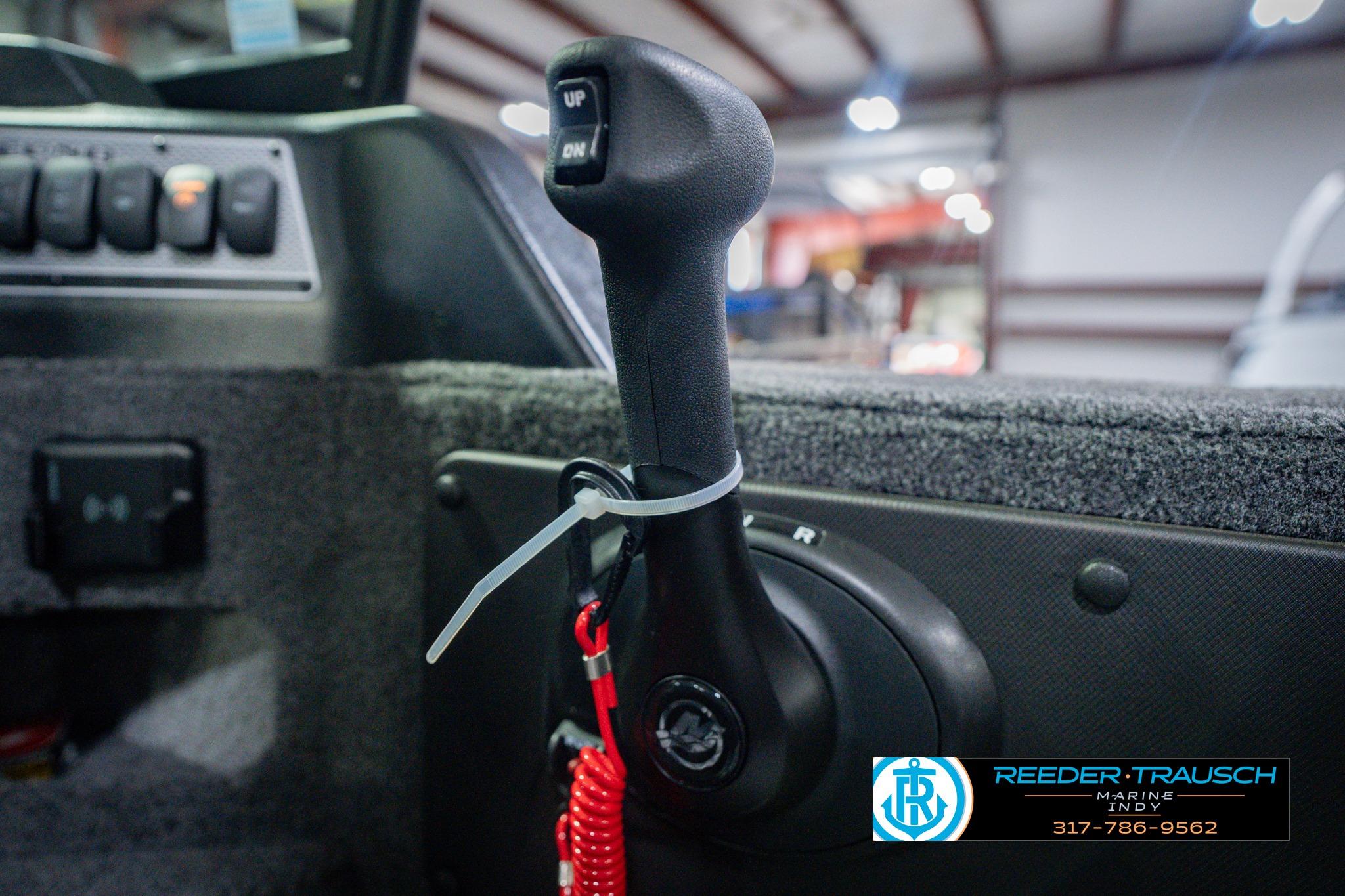 Close-up of 2026 Lund 1775 Impact XS boat throttle control in a showroom.