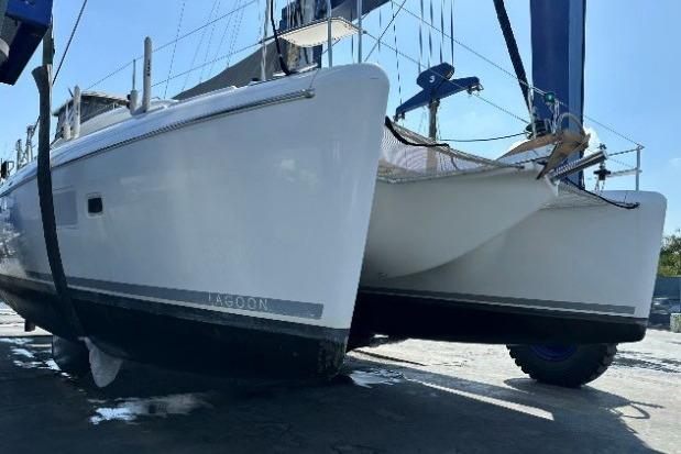 2010 Lagoon 421 catamaran on dry dock, showcasing sleek hull design and modern features.