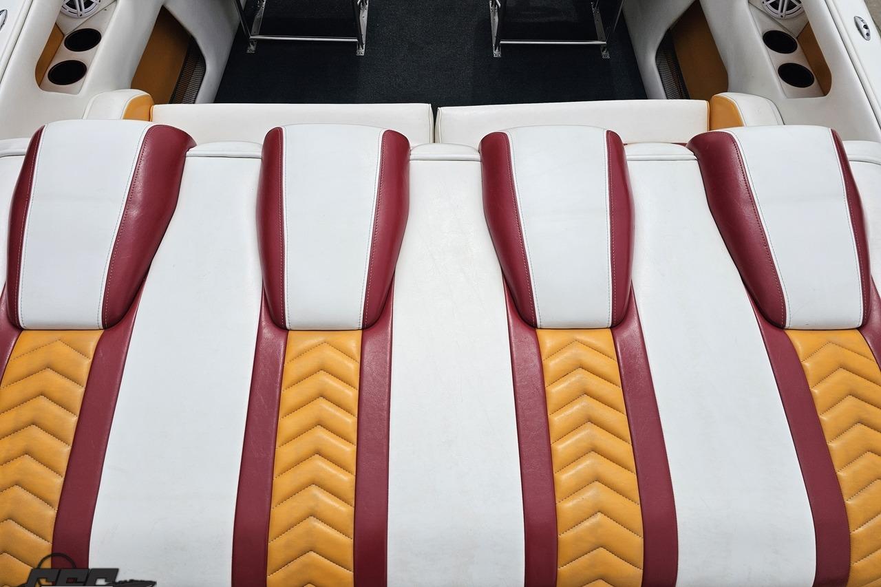 Luxury seating in 2008 Caliber 1 2550 Xcellerator MCOB boat, featuring red and yellow accents.