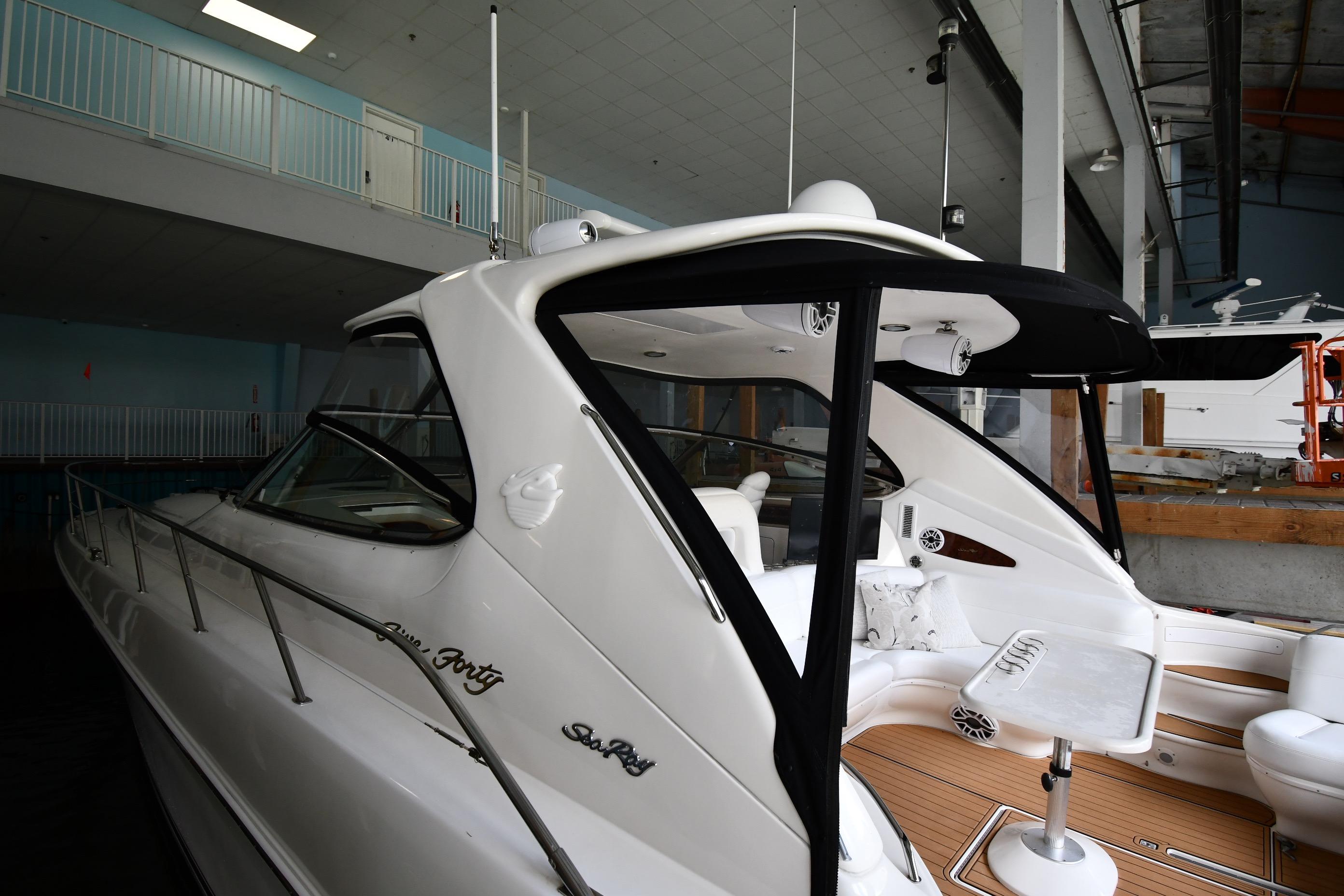 2001 Sea Ray 540 Sundancer yacht in indoor storage, showcasing sleek design and luxury features.