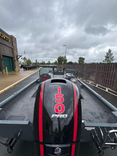 2024 Ranger VS1782SC Angler boat with 150 Pro engine, parked outdoors on a cloudy day.
