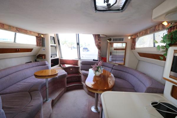 Interior of 1992 Sea Ray 350 Express Bridge with spacious seating and dining area.