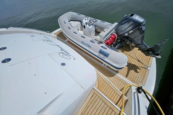 Sunseeker Manhattan 66 yacht with inflatable boat and Yamaha motor on deck, 2005 model.