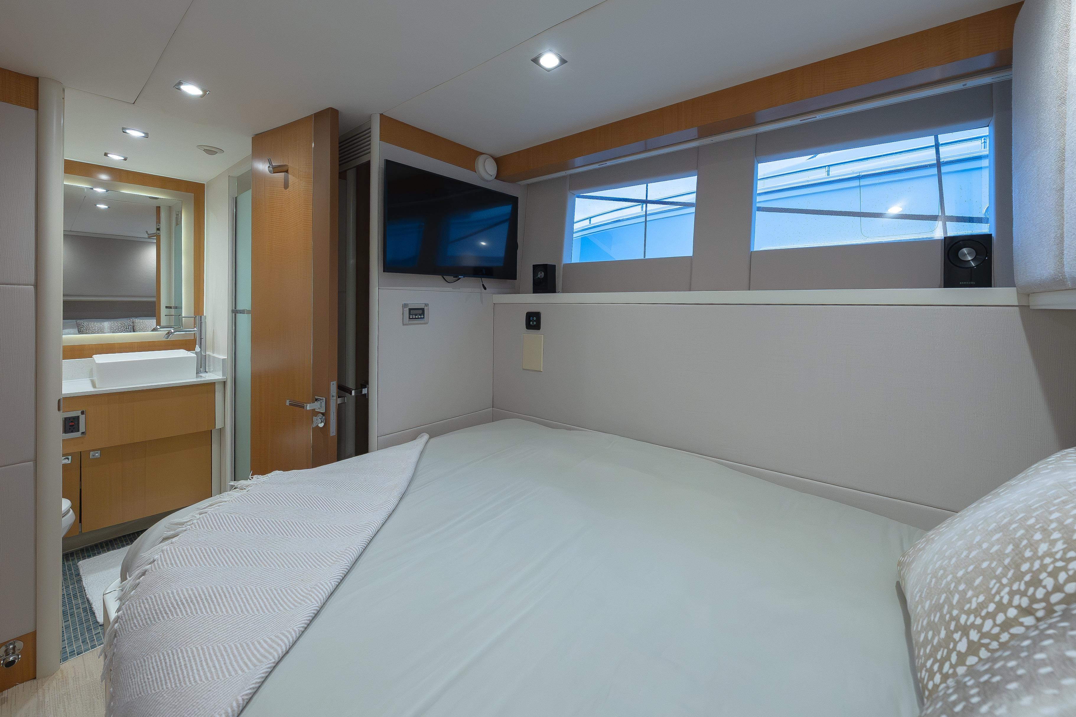 Luxurious 2012 Lazzara Breeze yacht bedroom with modern decor and ensuite bathroom.