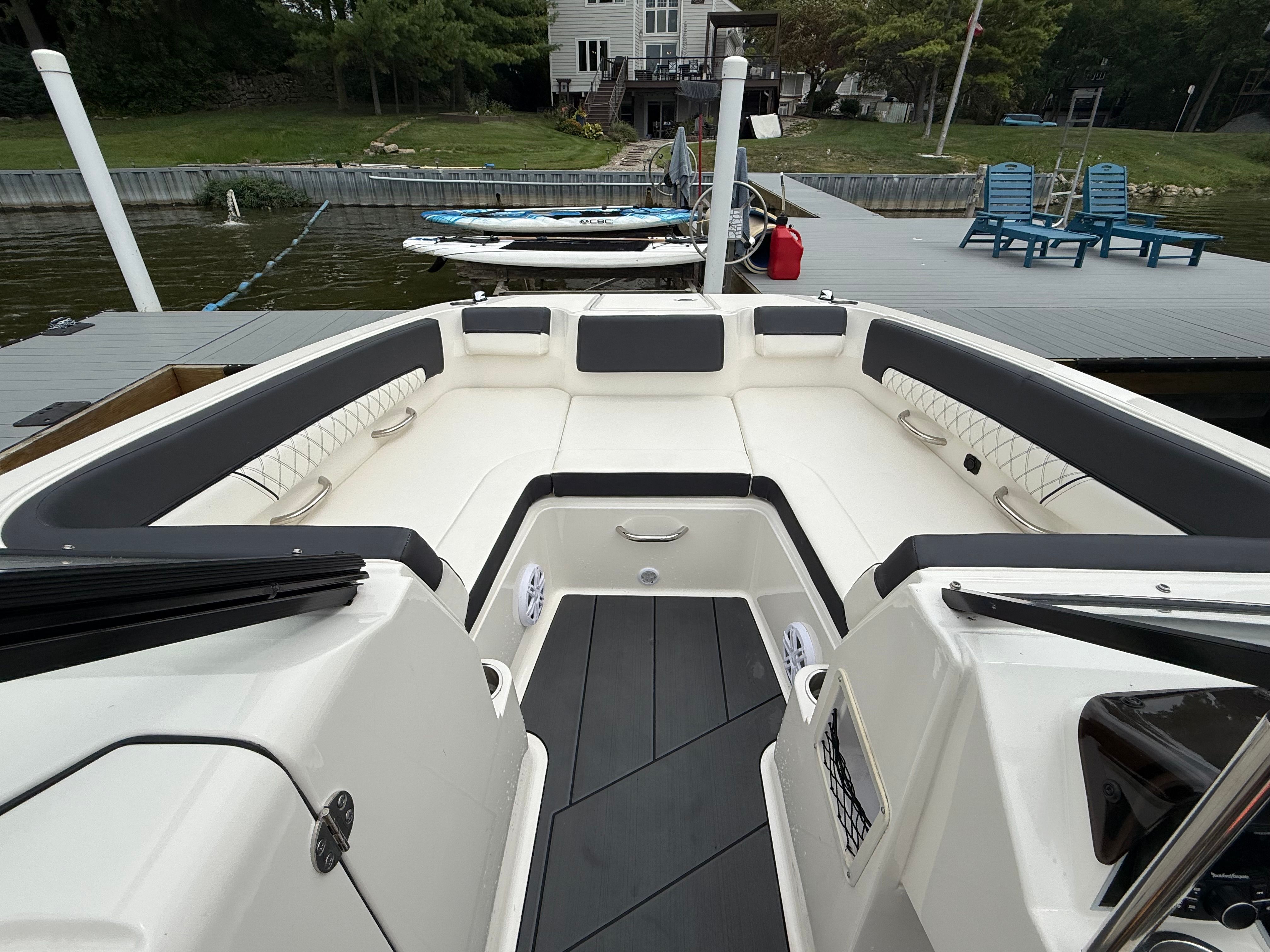 2022 Bayliner DX 2250 boat interior with spacious seating at a dock.