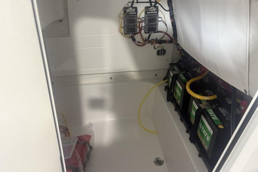 Electrical compartment of 2026 Sportsman Masters 227 boat with batteries and wiring.