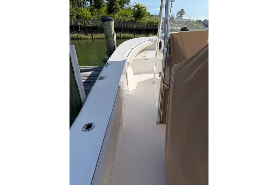 2014 Southport 29 FE boat docked, showcasing sleek deck design and spacious walkway.