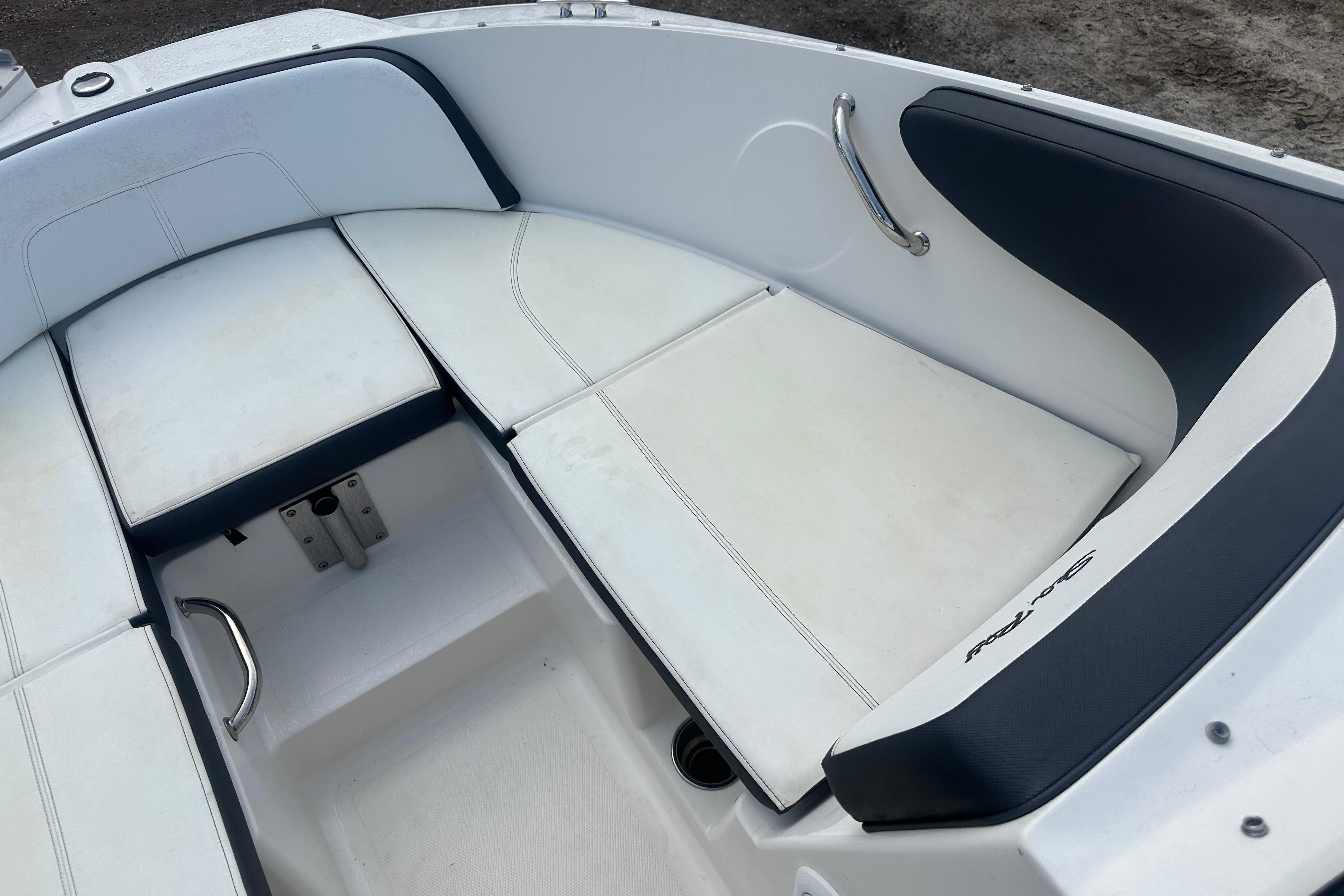 2017 Sea Ray SPX 190 Outboard boat interior with white cushioned seating and stainless steel handles.