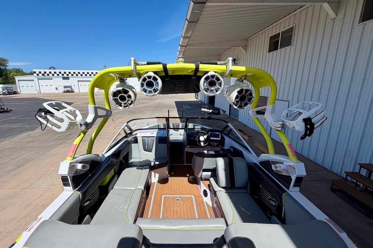 2014 Nautique Super Air Nautique G21 boat interior with vibrant yellow tower and speakers.