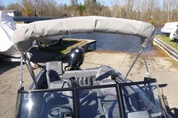 2026 Ranger 2080MS boat with canopy, docked near a serene lake.