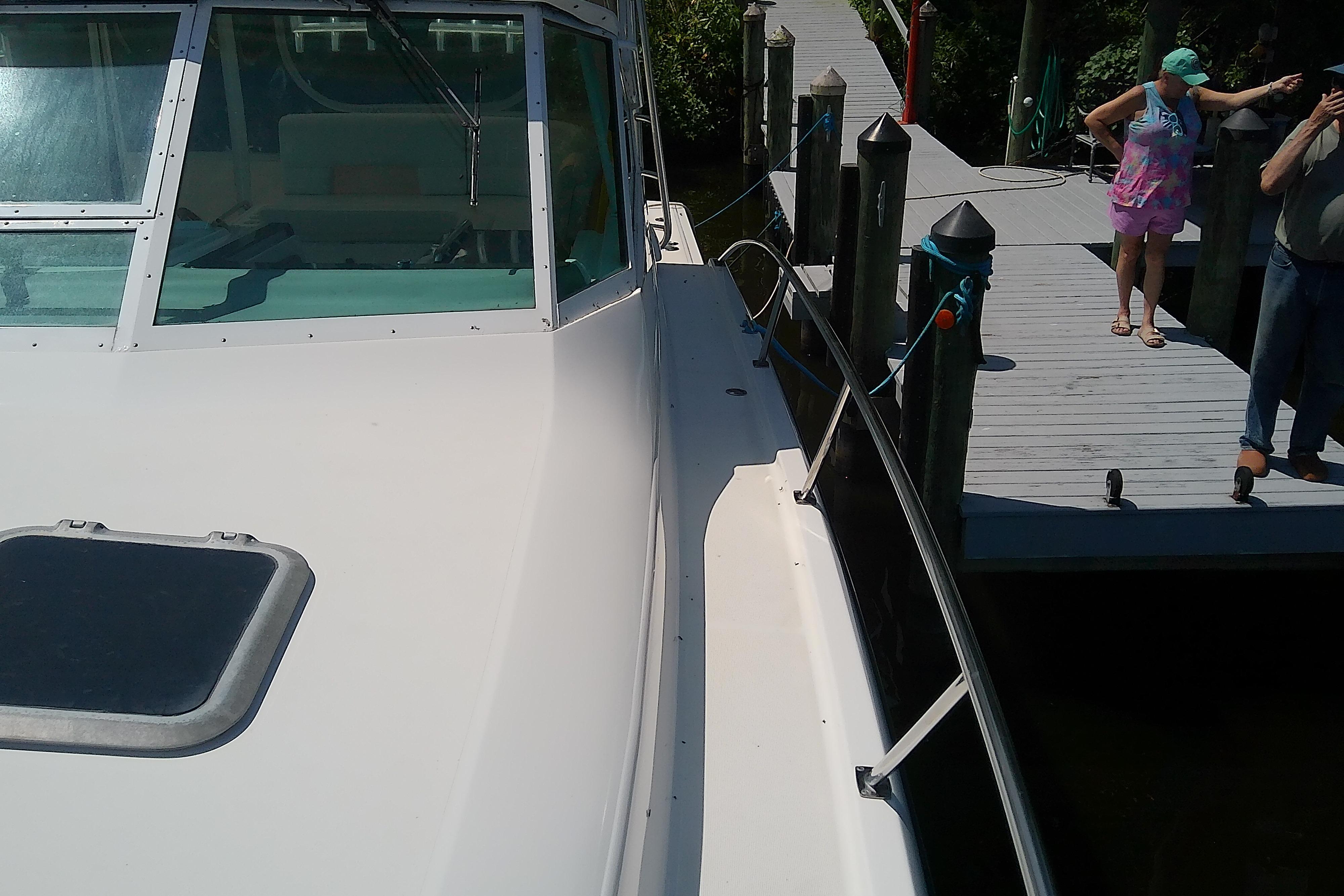2000 Tiara Yachts 4100 Open docked, with people standing on the pier.