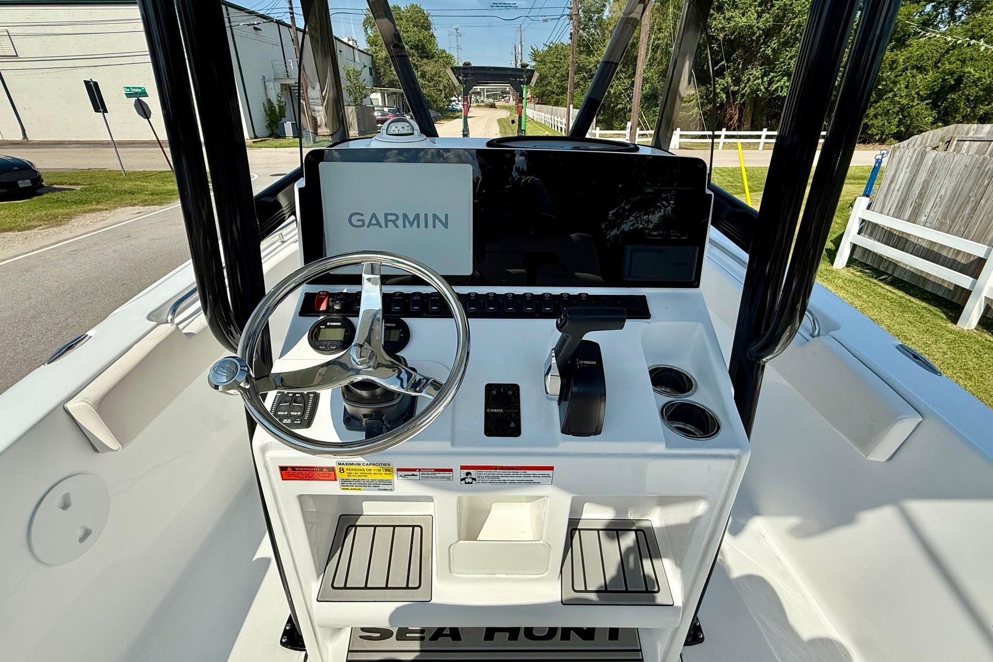 2026 Sea Hunt Ultra 229 boat console with Garmin navigation system and steering wheel.