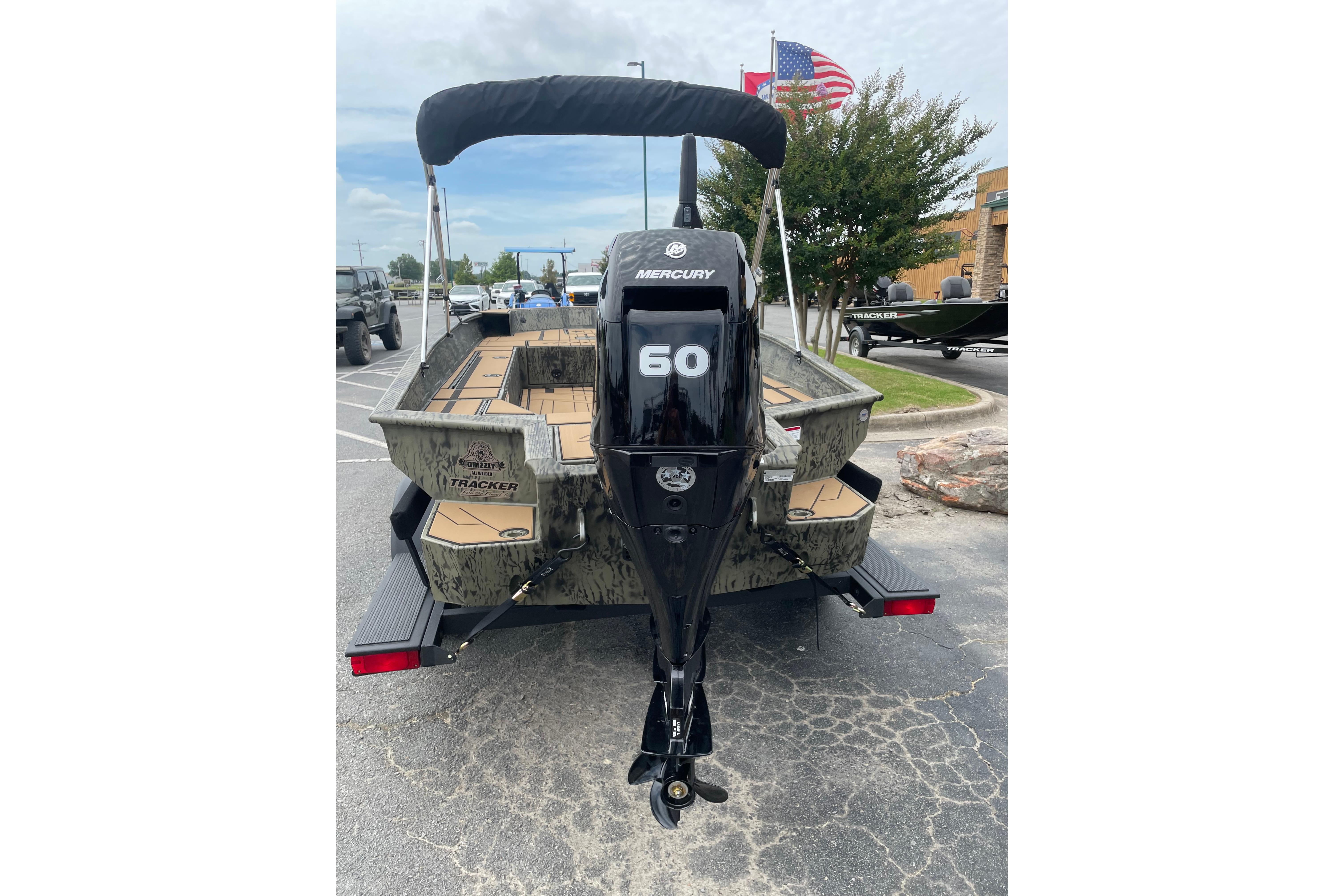 2026 Tracker Grizzly 1756 T Marsh boat with Mercury 60 outboard motor, parked outdoors.