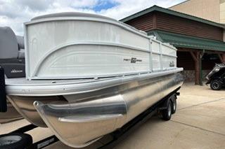 2026 Sun Tracker Party Barge 22 XP3 pontoon boat on trailer, parked outdoors.