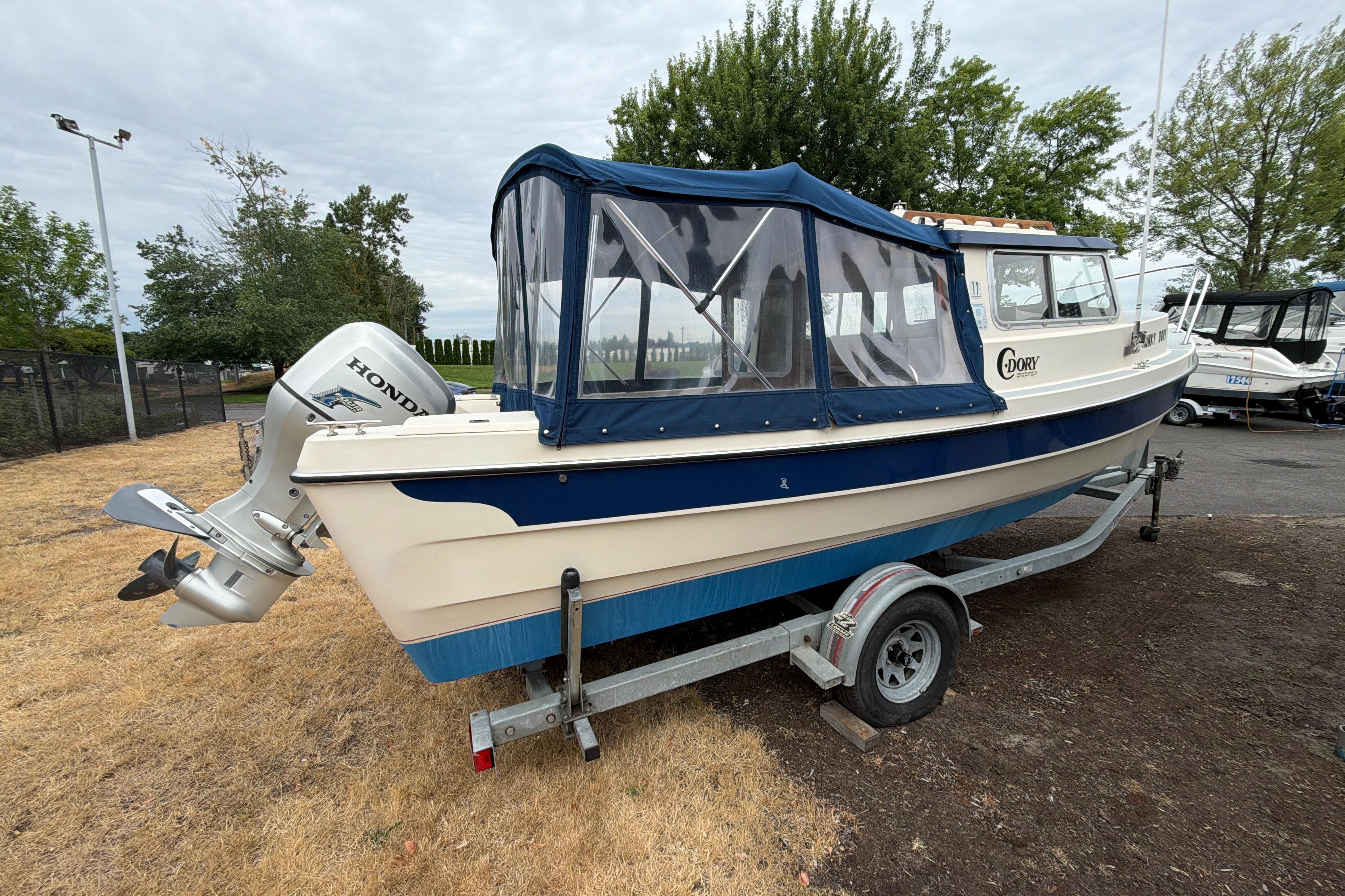 1989 C-Dory 22' Angler boat on trailer with Honda outboard motor.