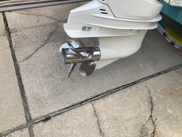 2006 Hurricane SunDeck 237 OB boat propeller on concrete surface.