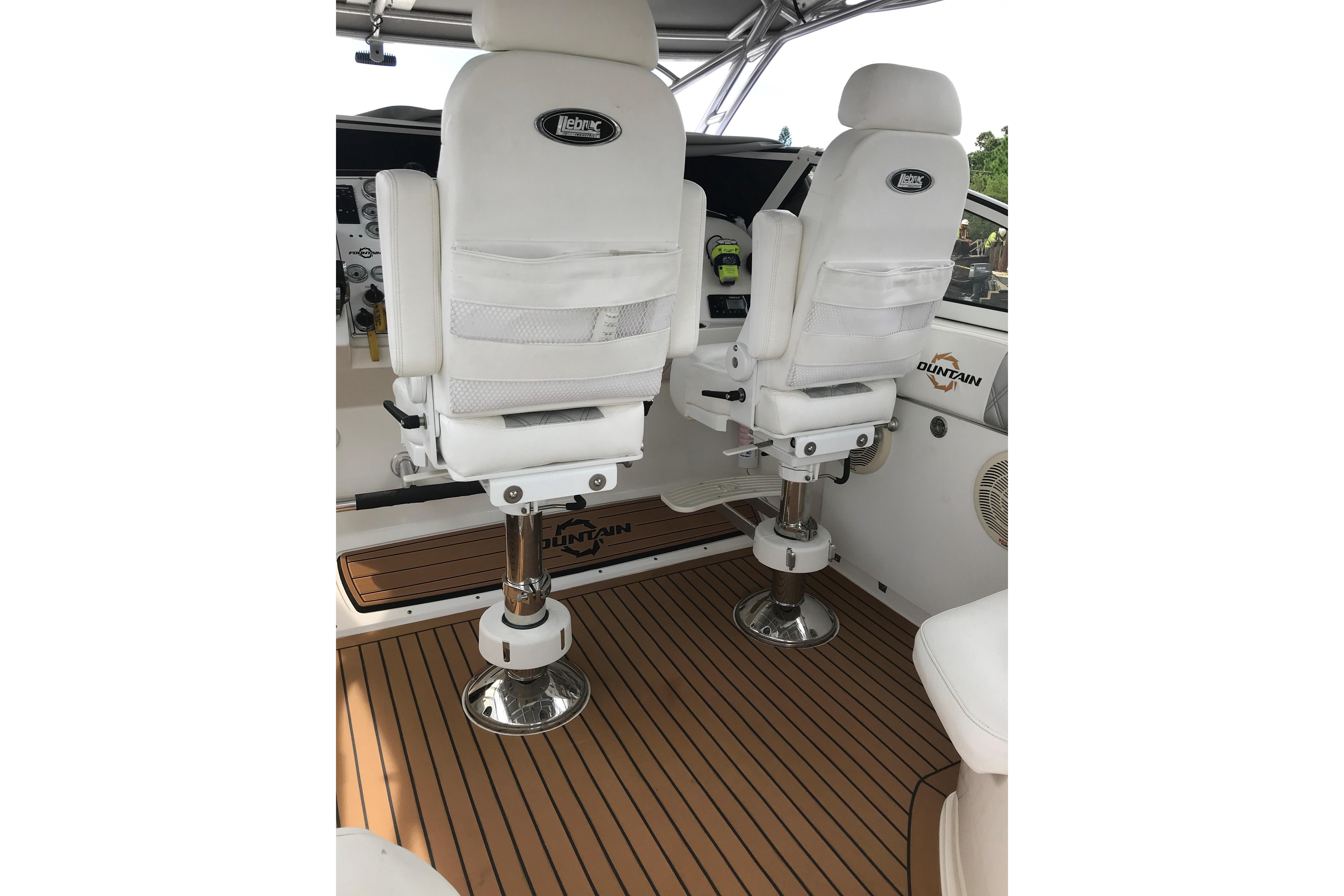 2007 Fountain 38 Sportfish Cruiser OB cockpit with white seats and teak flooring.