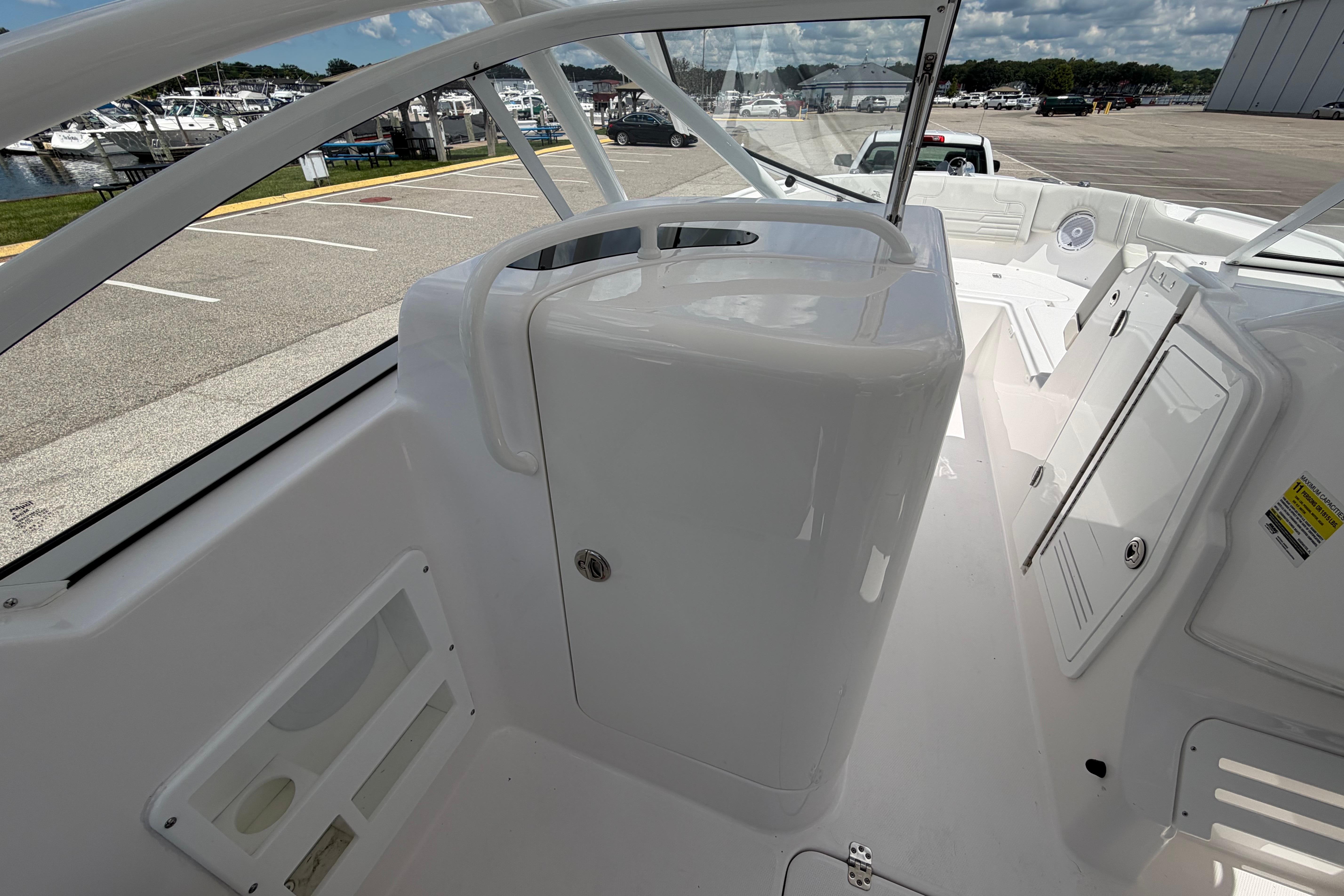 2026 Edgewater 248CX Crossover boat interior with sleek white design and storage compartments.