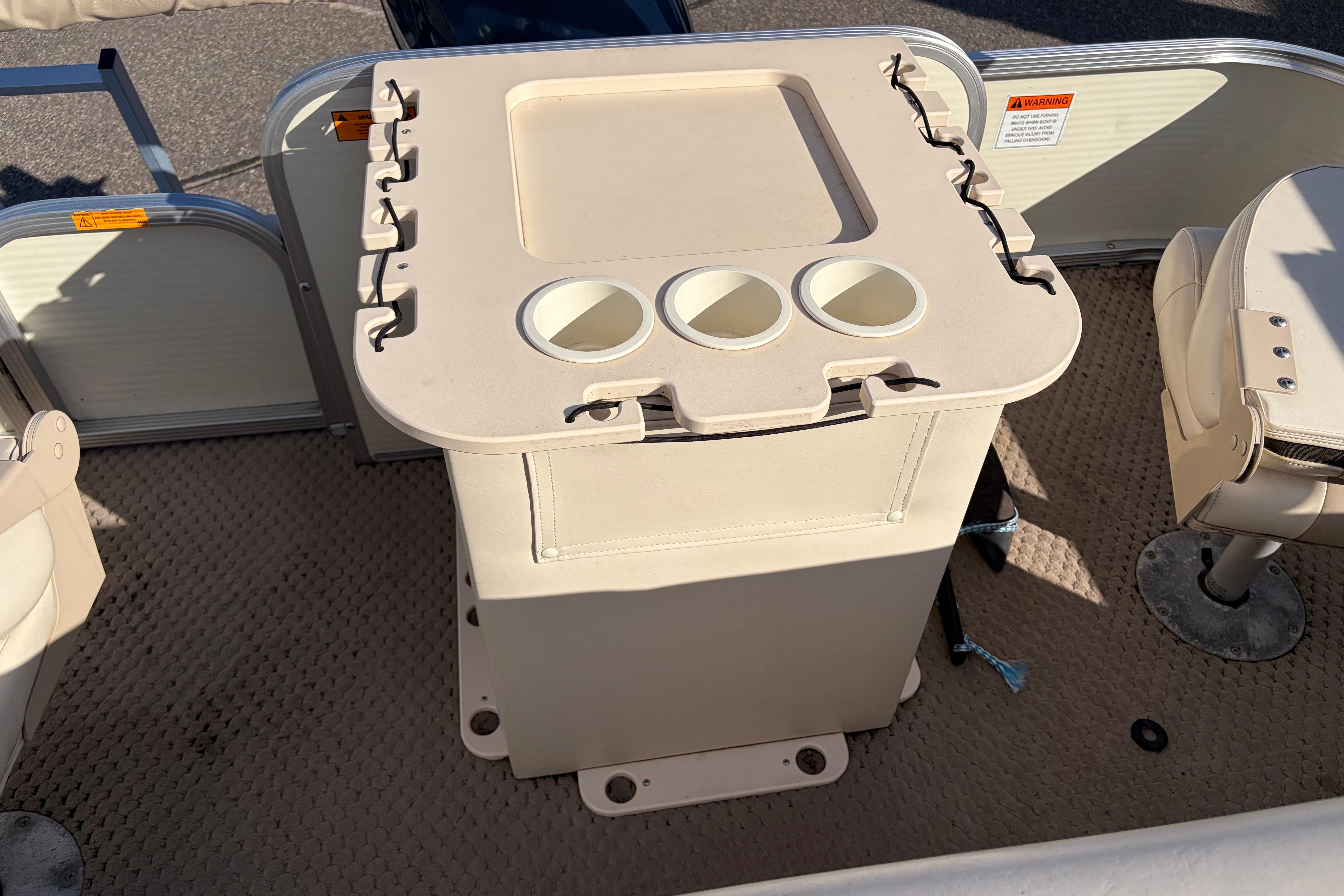 2003 Bennington 2250RSi boat interior with beige seating and cup holders.