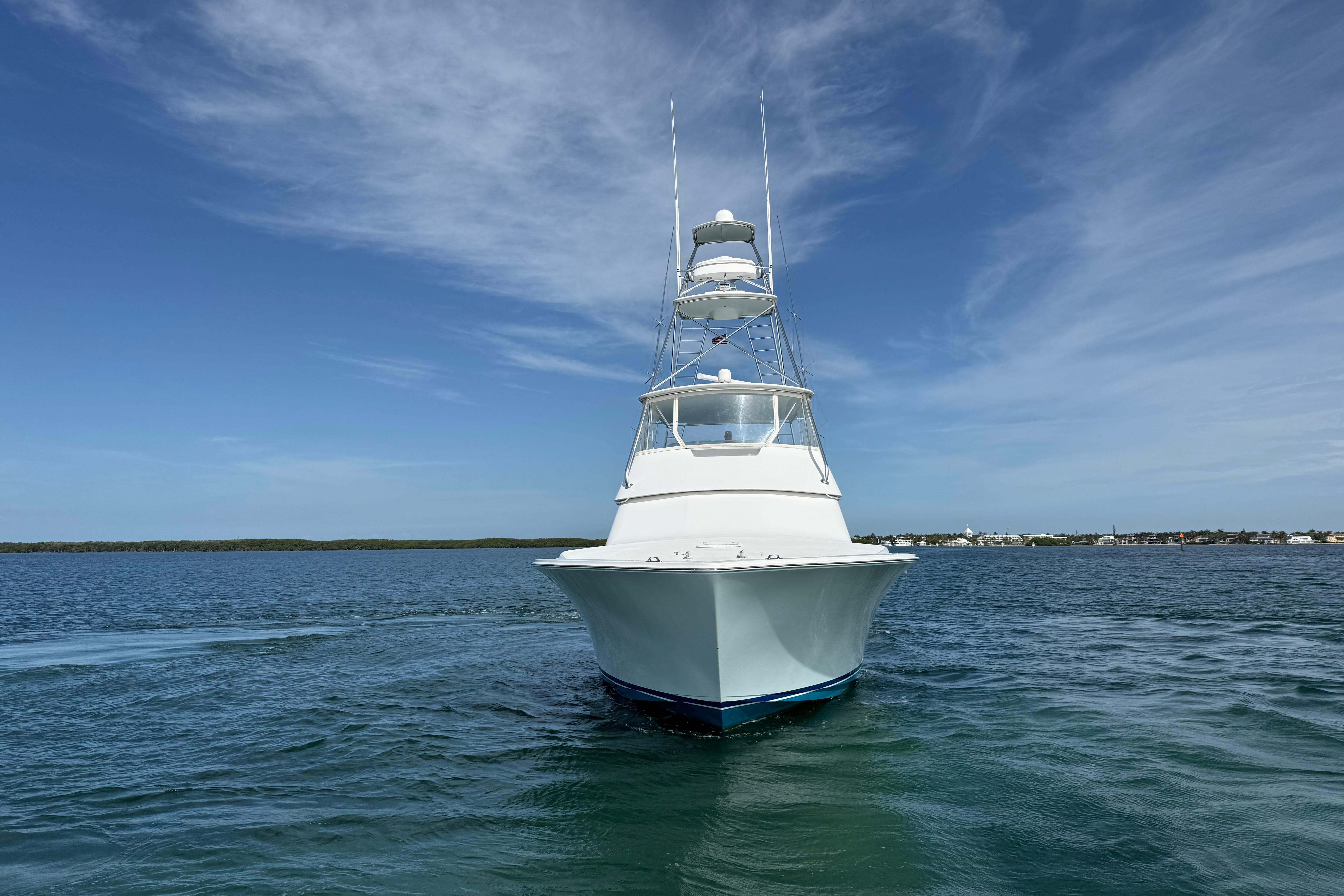 2000 Viking 55 Convertible yacht on calm blue waters under a clear sky.