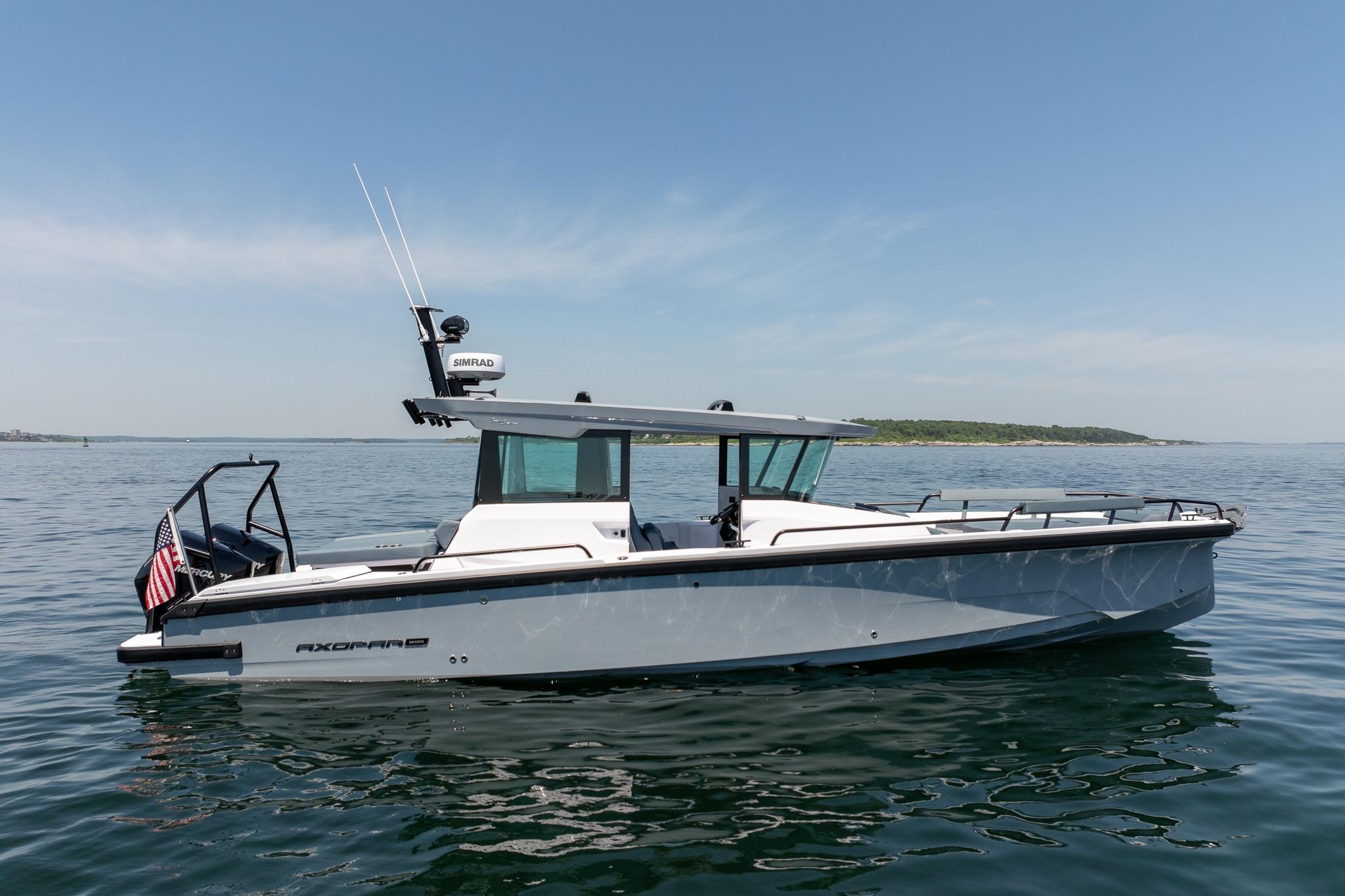 2026 Axopar 29 XC Cross Cabin boat on calm water, side view.