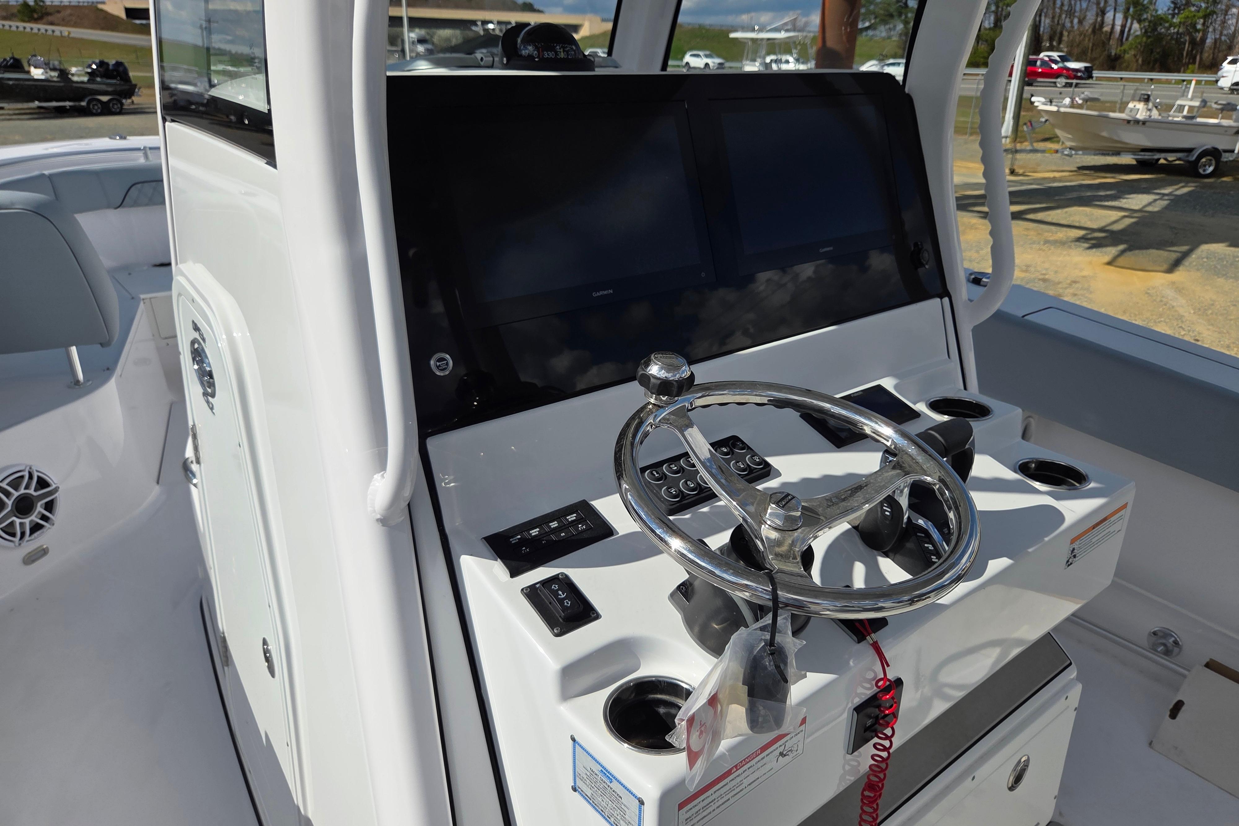 2026 Sportsman Open 282 Center Console boat dashboard with steering wheel and controls.