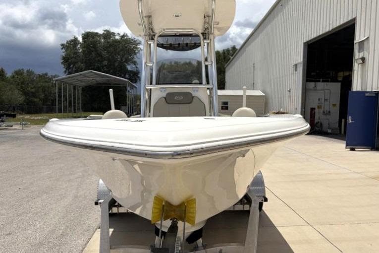 2023 Key West 203 FS boat on trailer outside a large warehouse.