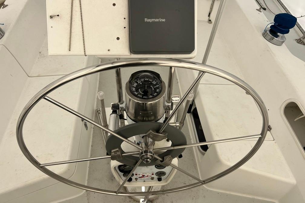 Steering wheel and compass on a 1998 Catalina 36 MkII sailboat.